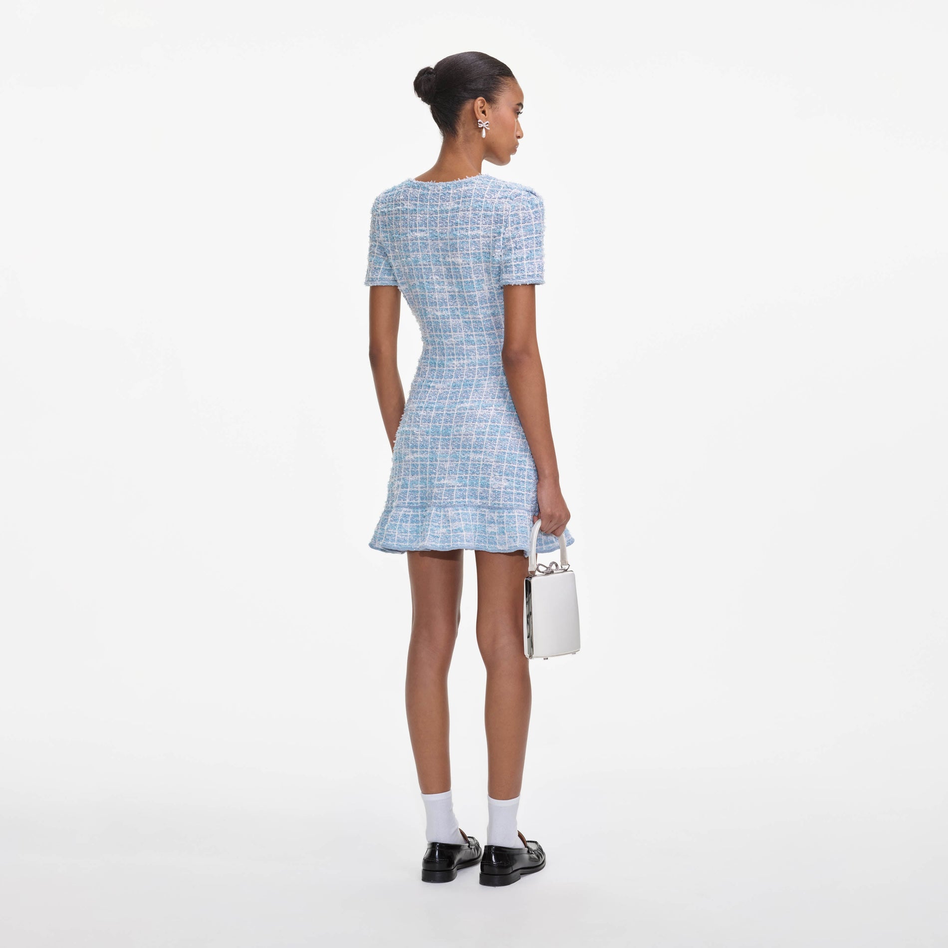 Back view of a woman wearing the Blue Check Knit Mini Dress