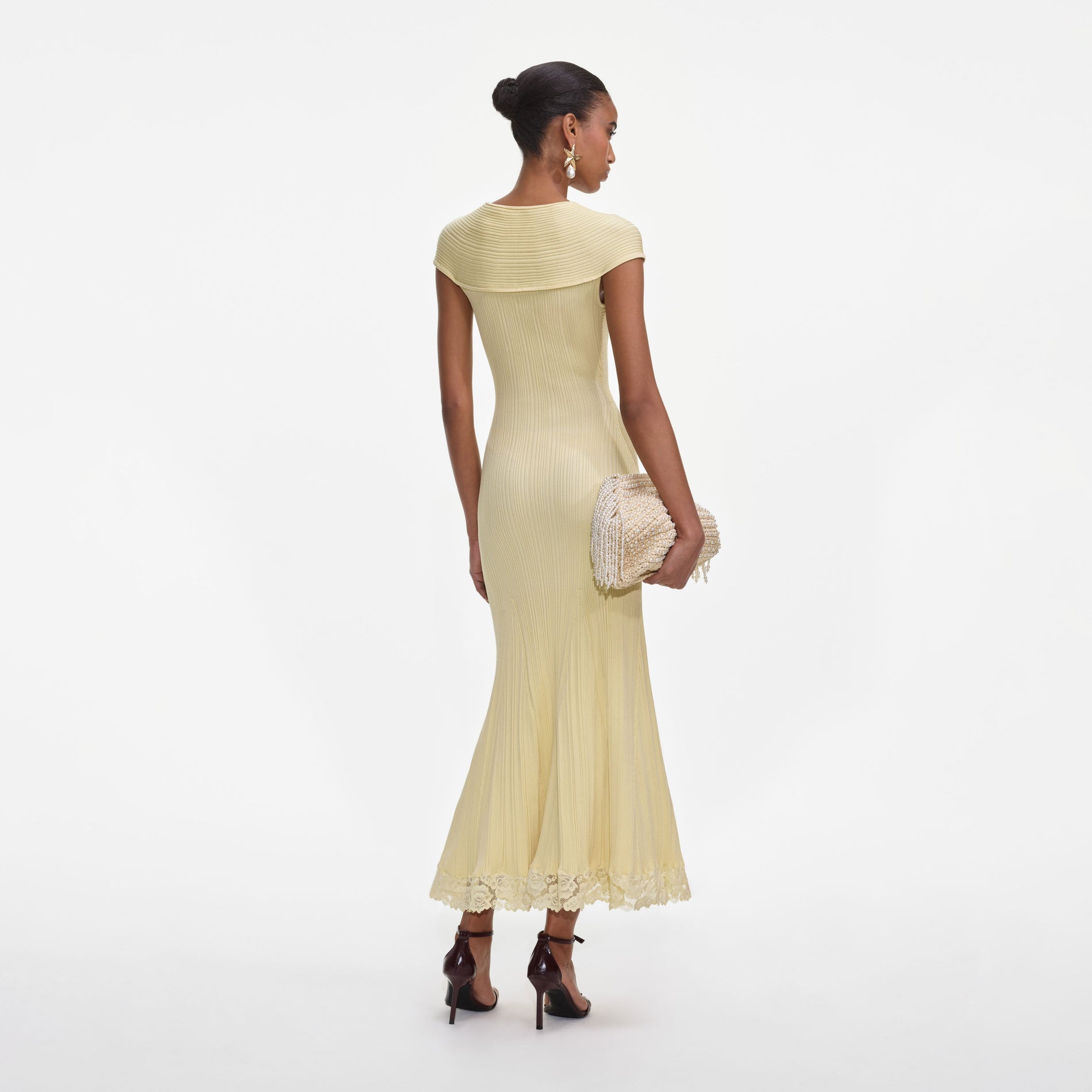 Back view of a woman wearing the Yellow Knit Lace Insert Midi Dress