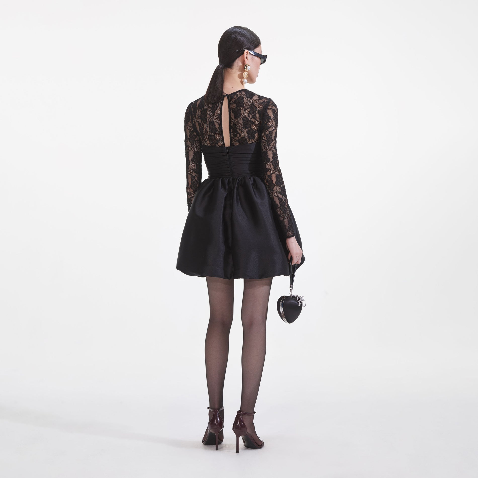 Back view of a woman wearing the Black Taffeta Lace Mini Dress