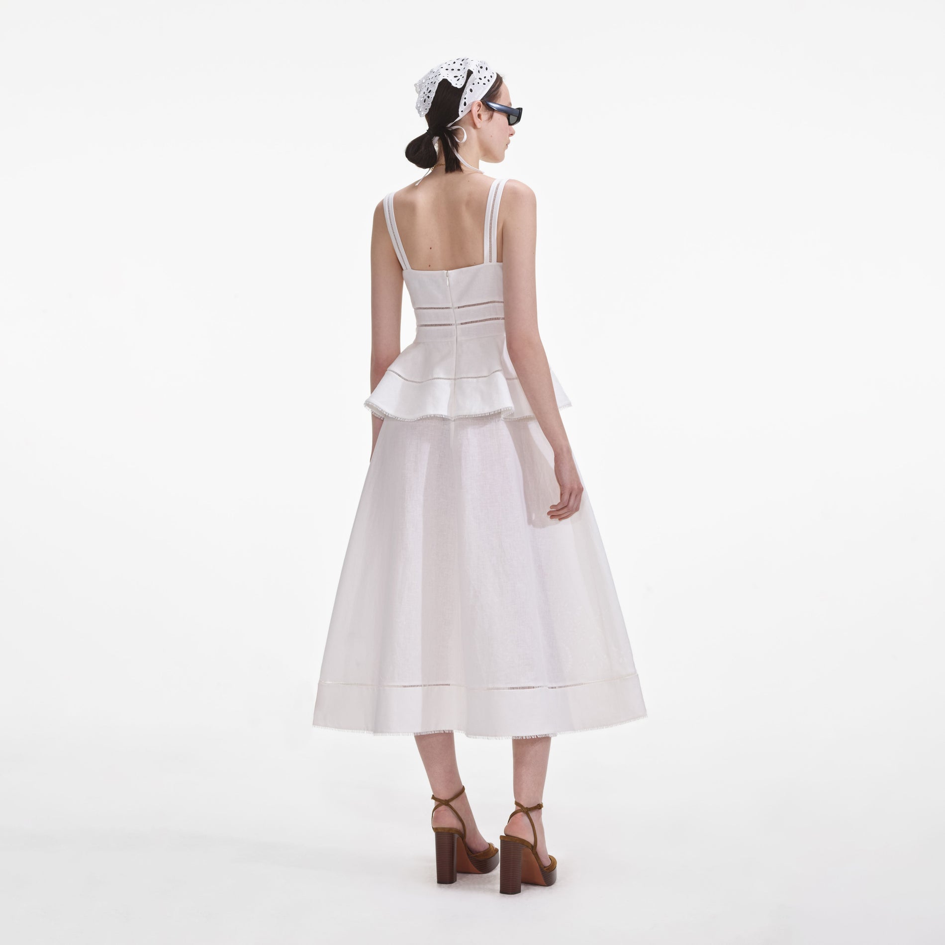 Back view of a woman wearing the Cream Linen Peplum Midi Dress