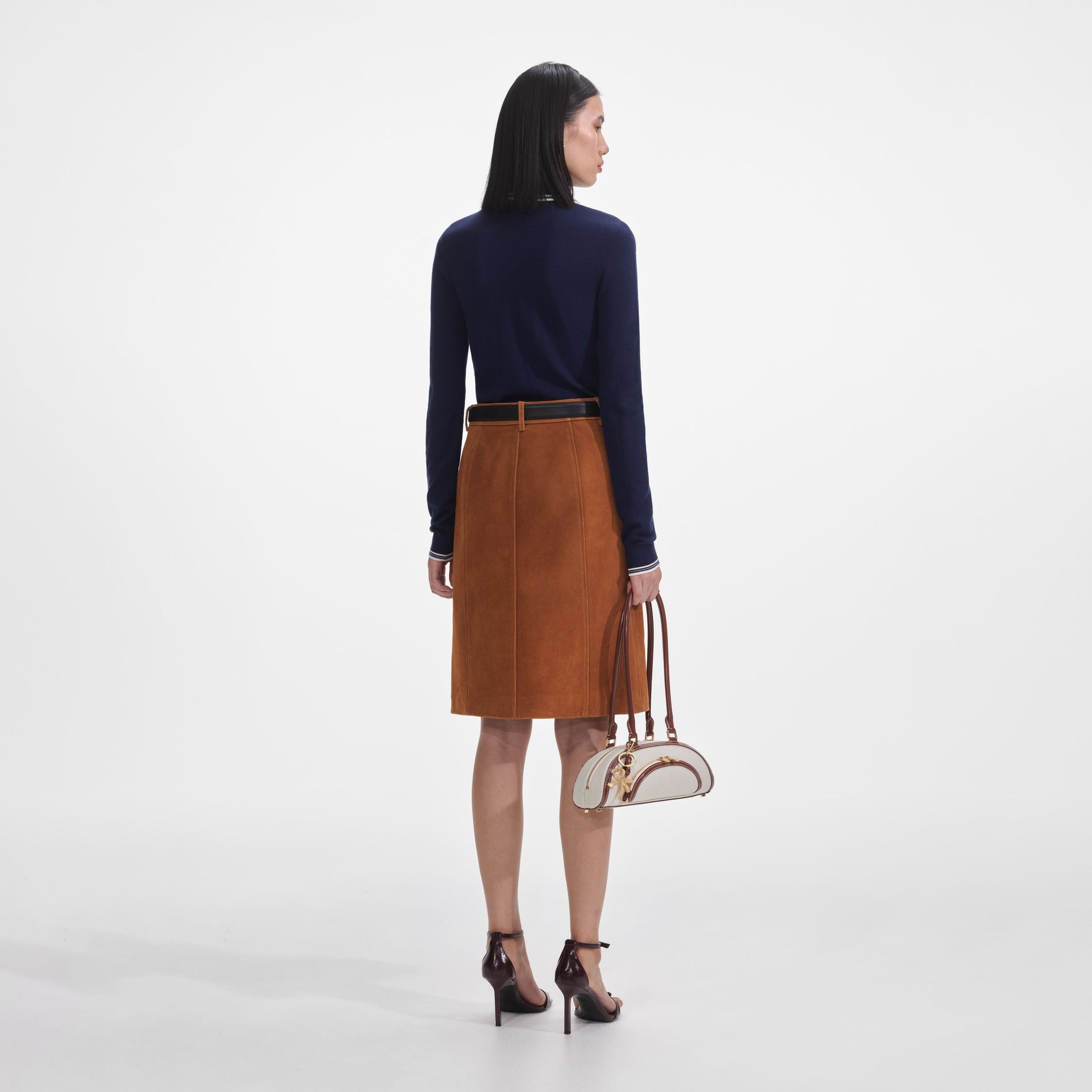 Back view of a woman wearing the Brown Suede Midi Skirt