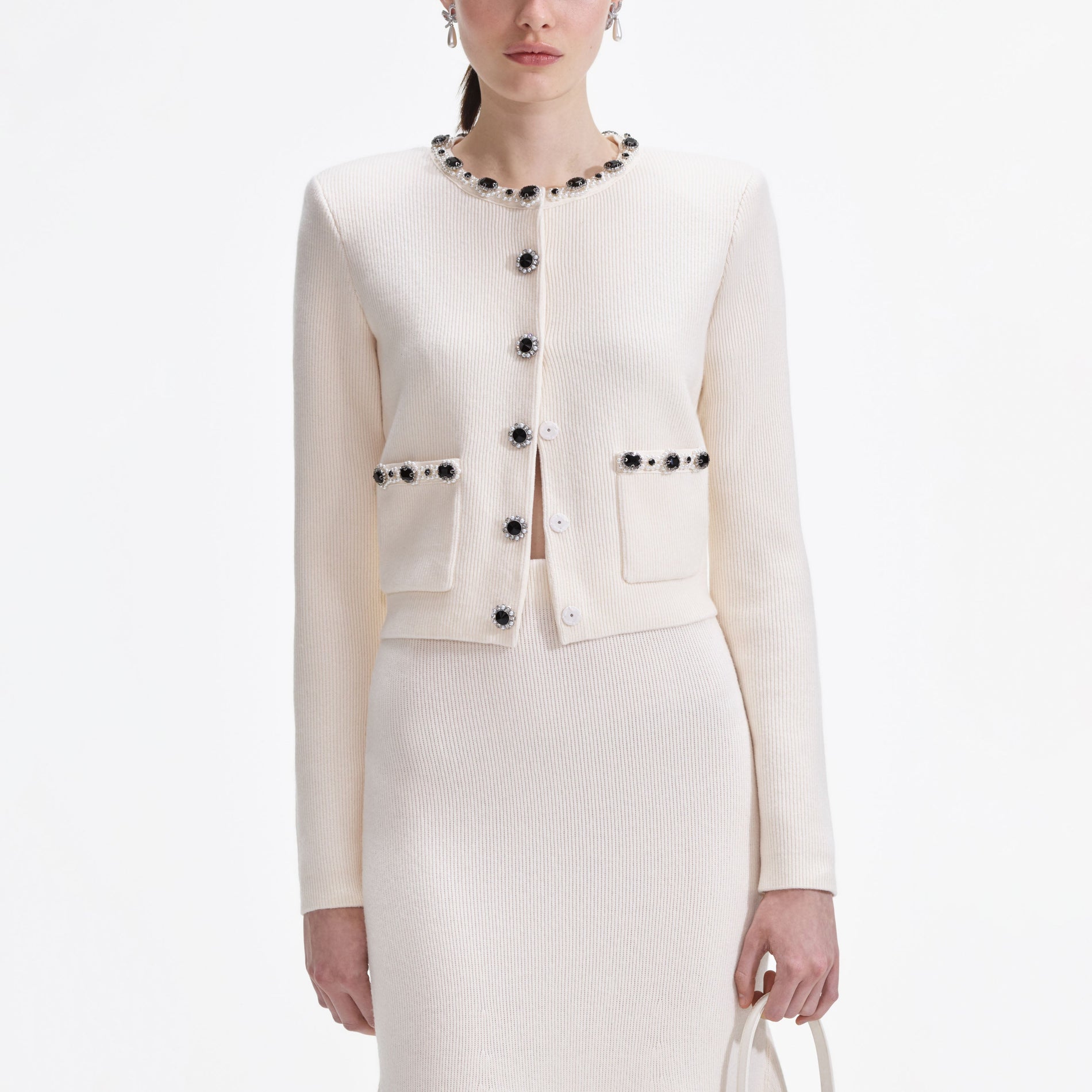 Side view of a woman wearing the Cream Embellished Cardigan