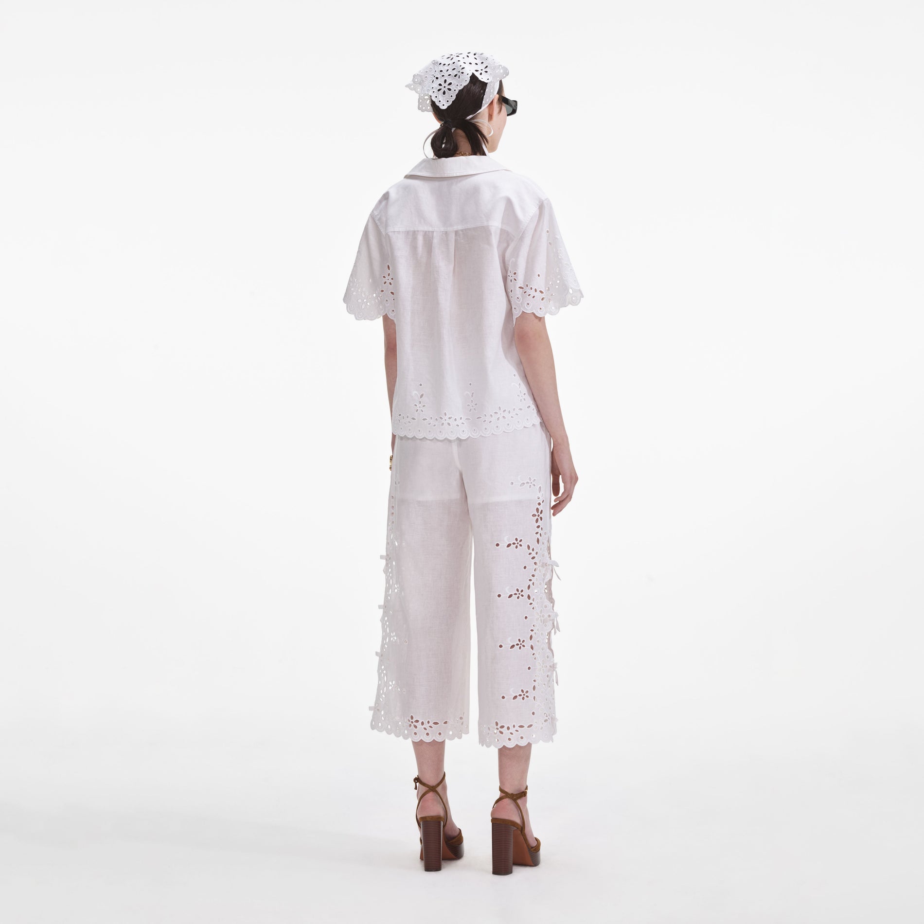 Back view of a woman wearing the Cream Linen Embroidered Shirt