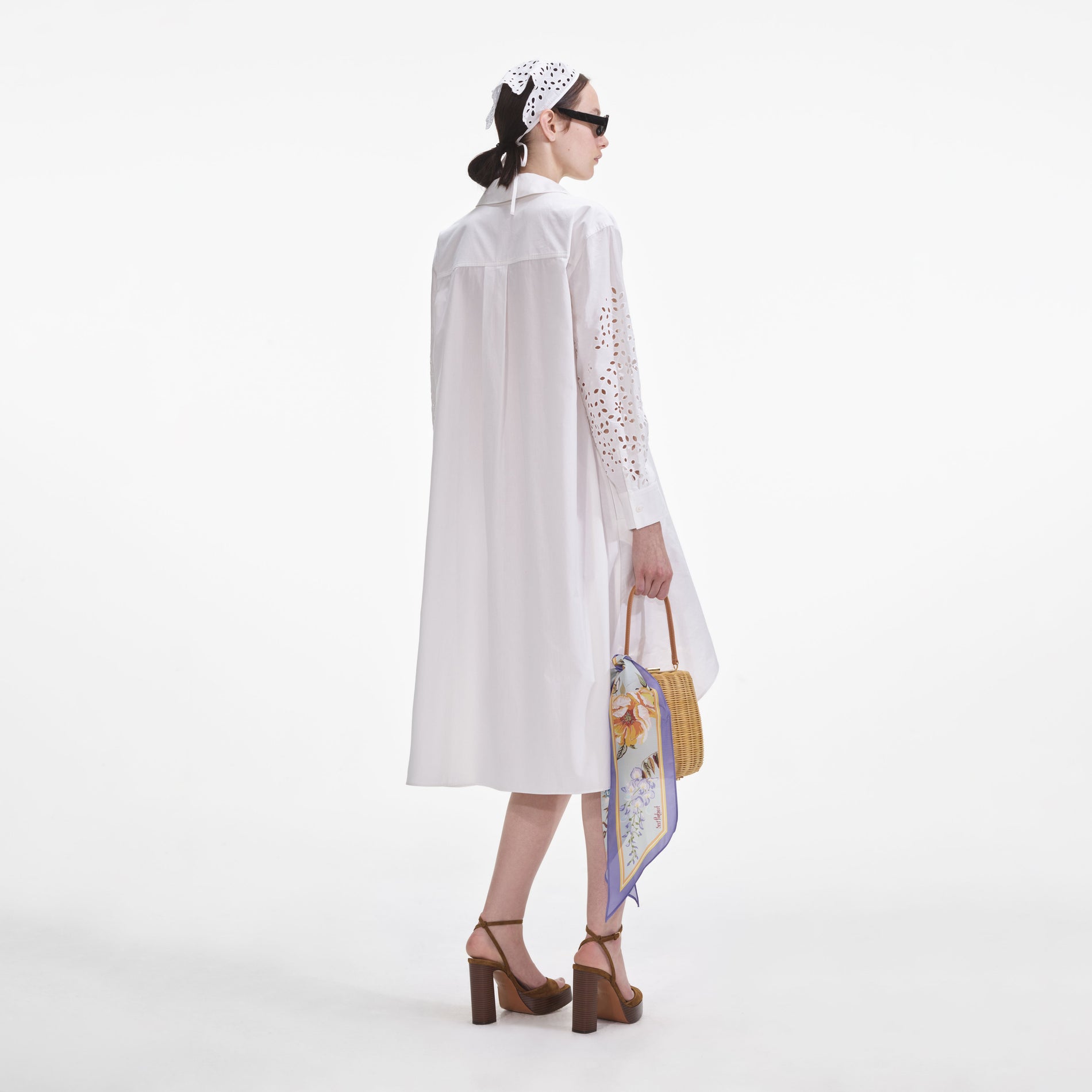 Back view of a woman wearing the White Cotton Embroidered Shirt Dress