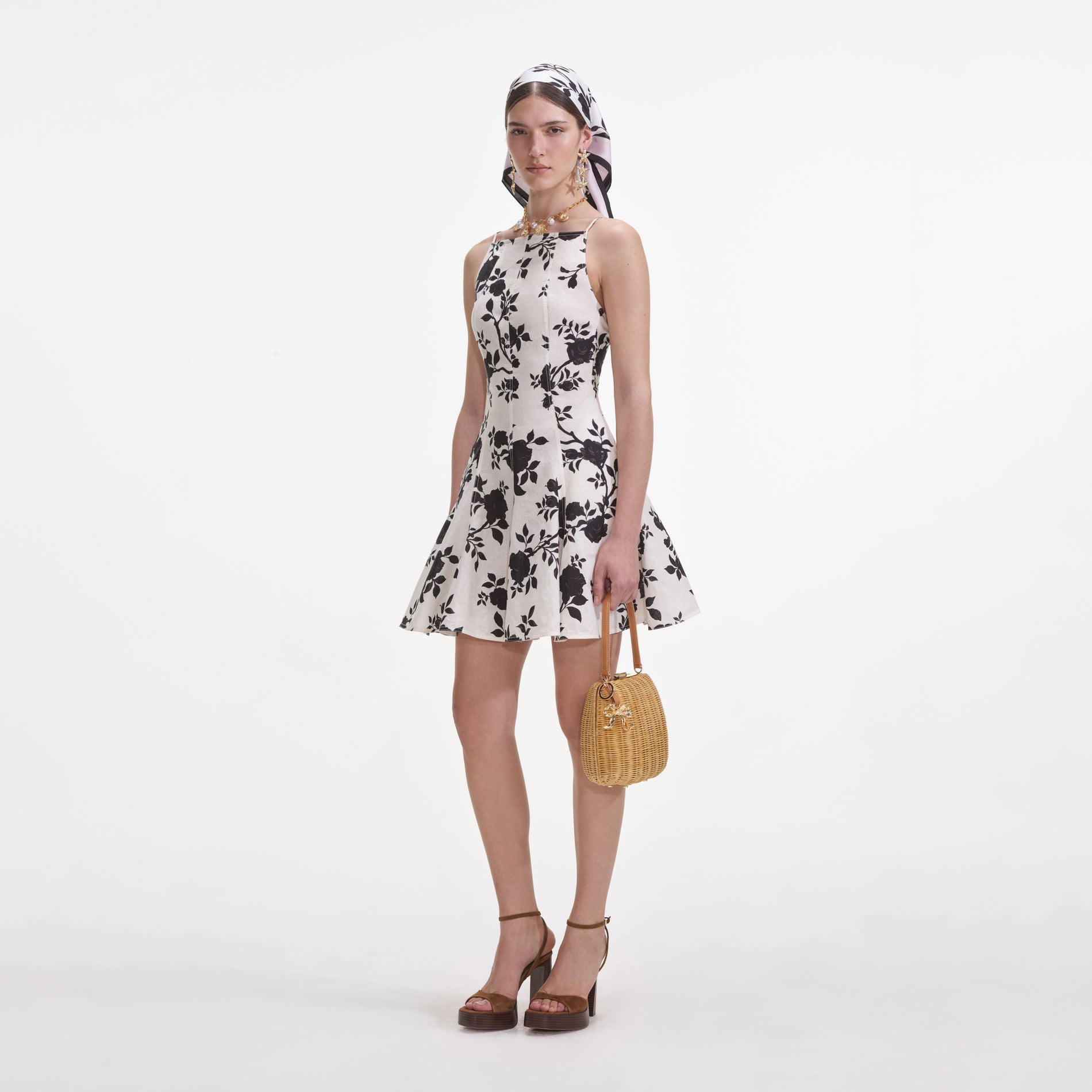 Side view of a woman wearing the Floral Print Linen Mini Dress