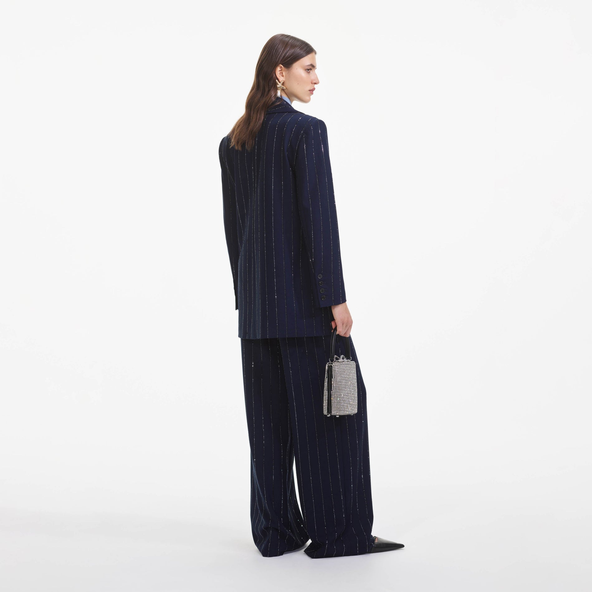 Back view of a woman wearing the Navy Rhinestone Pinstripe Trousers