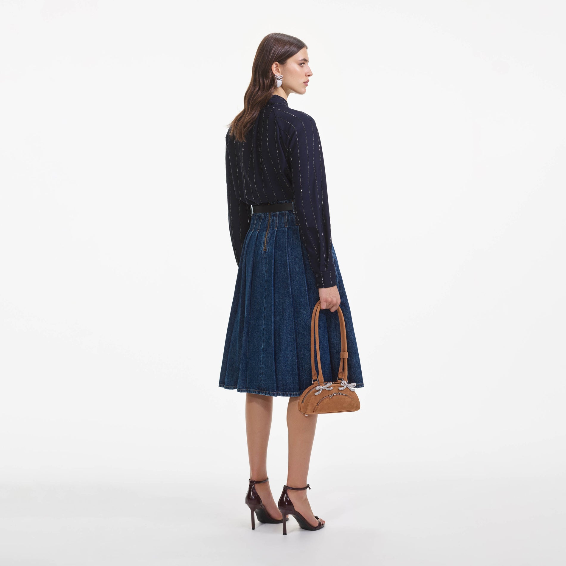 Back view of a woman wearing the Navy Rhinestone Pinstripe Blouse