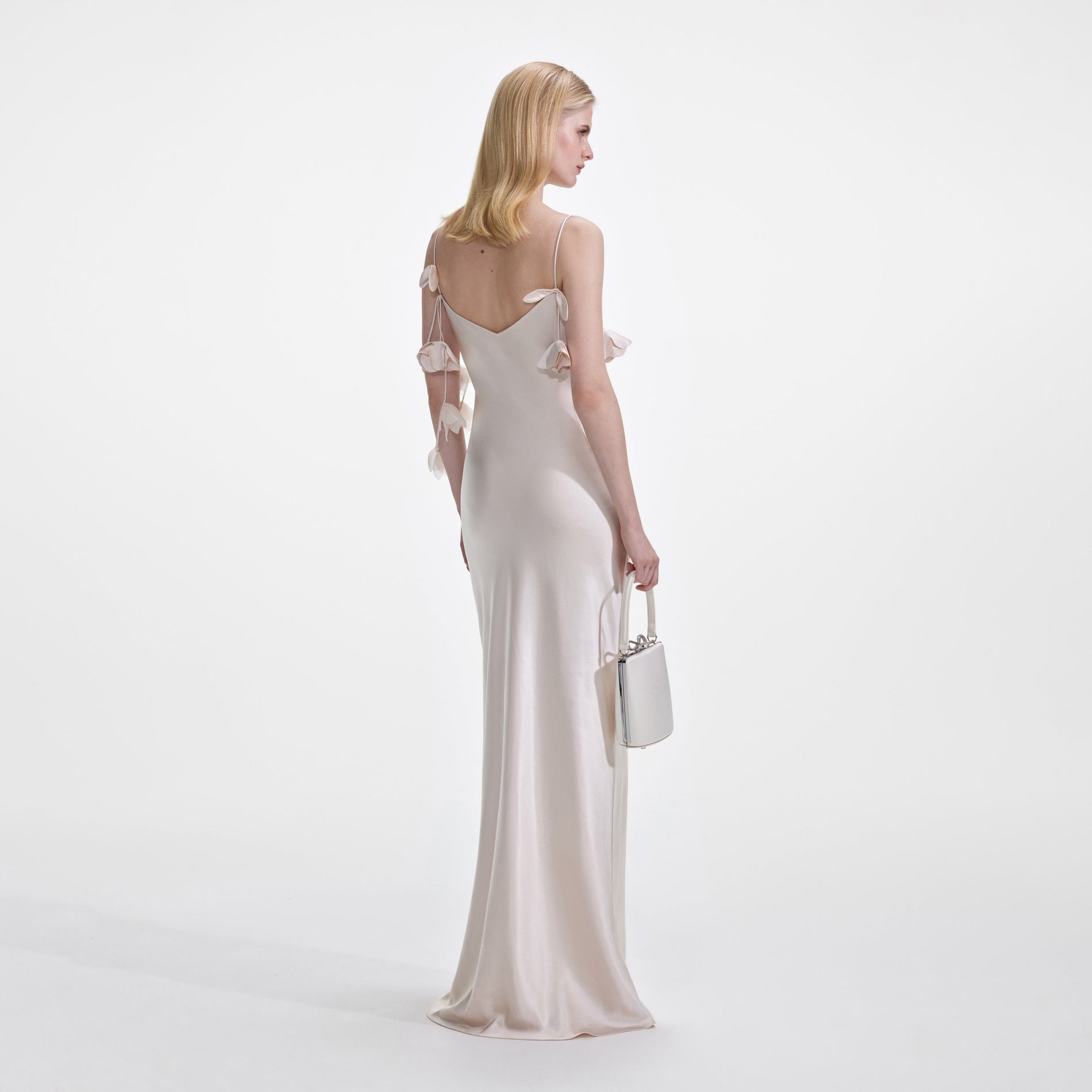 Back view of a woman wearing the Champagne Flower Satin Maxi Dress