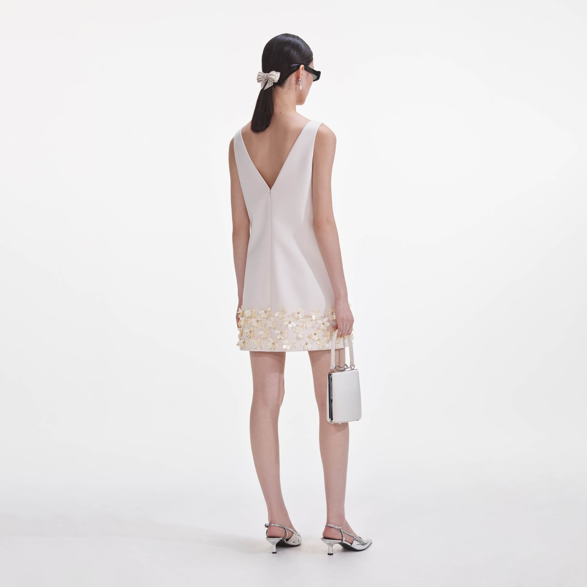 Back view of a woman wearing the Cream Crepe 3D Sequin Mini Dress