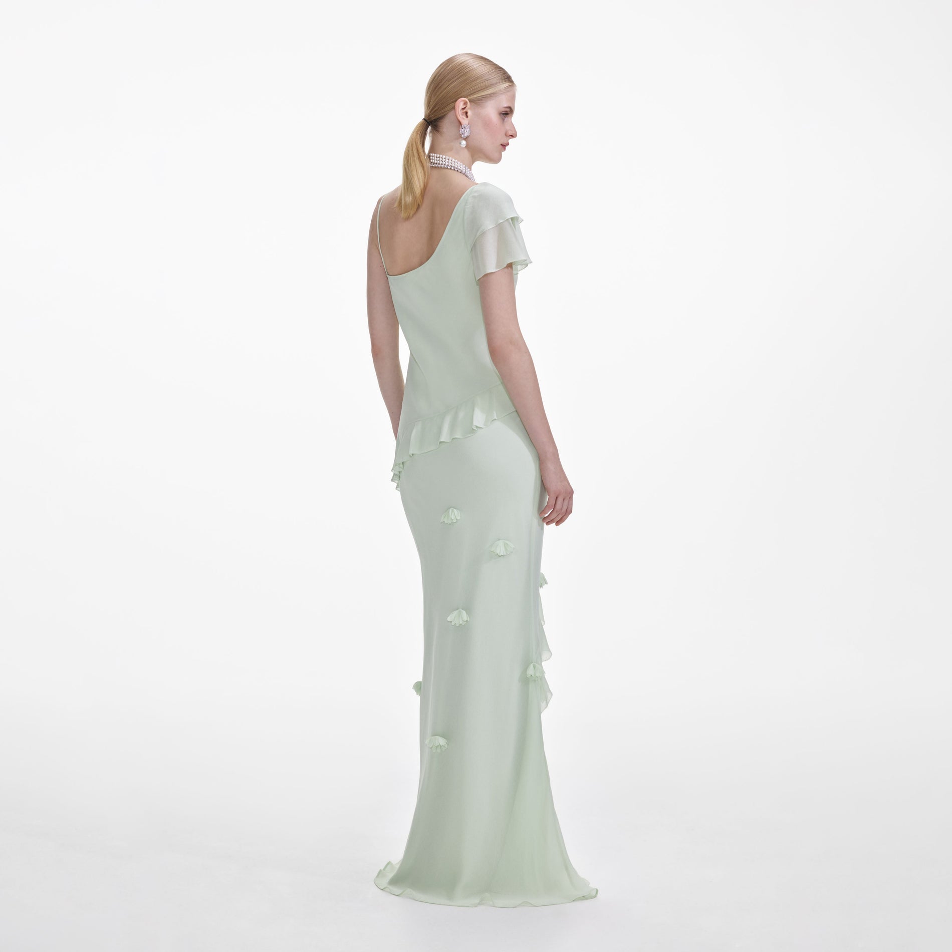 Back view of a woman wearing the Mint Georgette Flower Maxi Dress