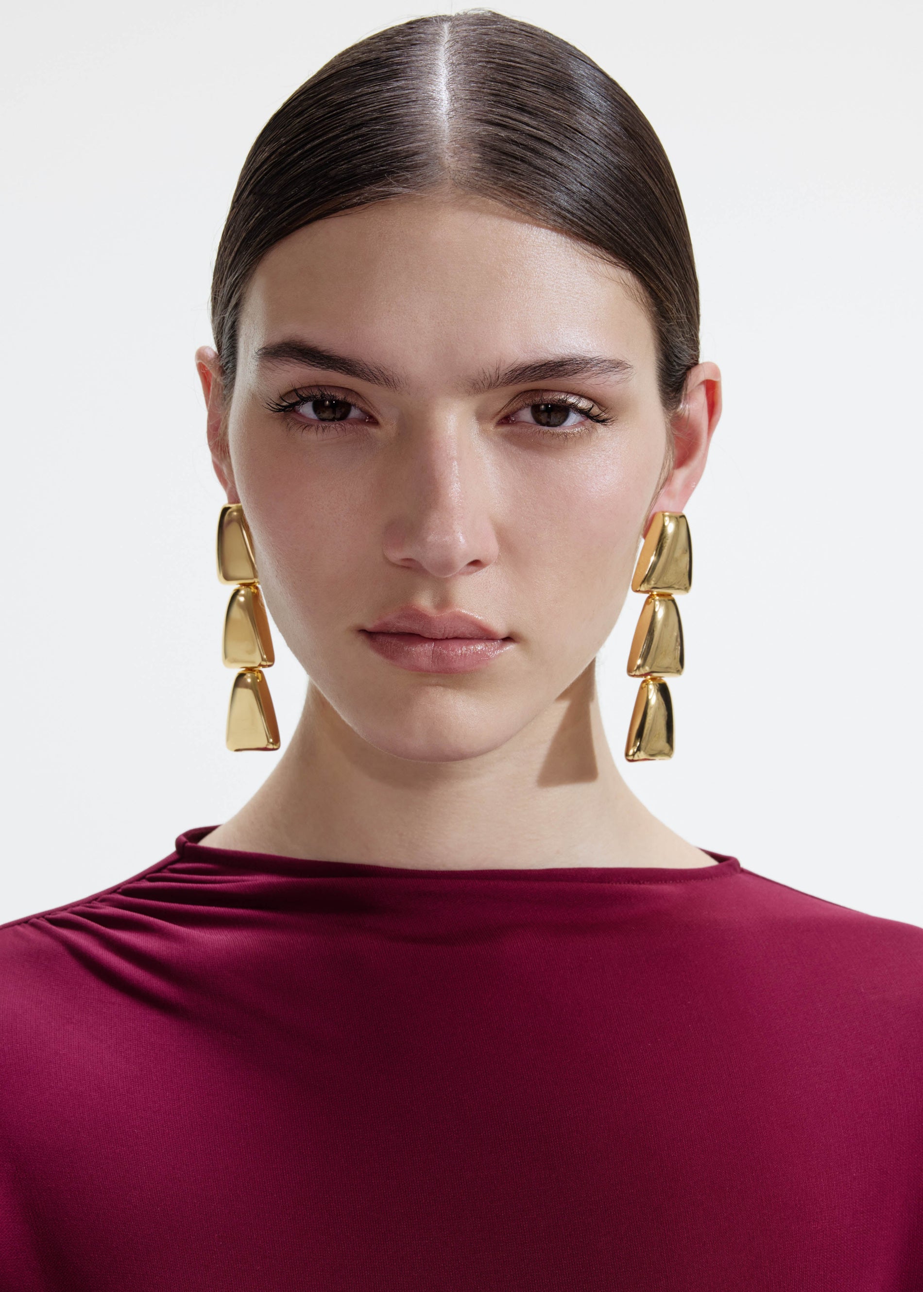 A photo of the Gold Tiered Bell Earrings