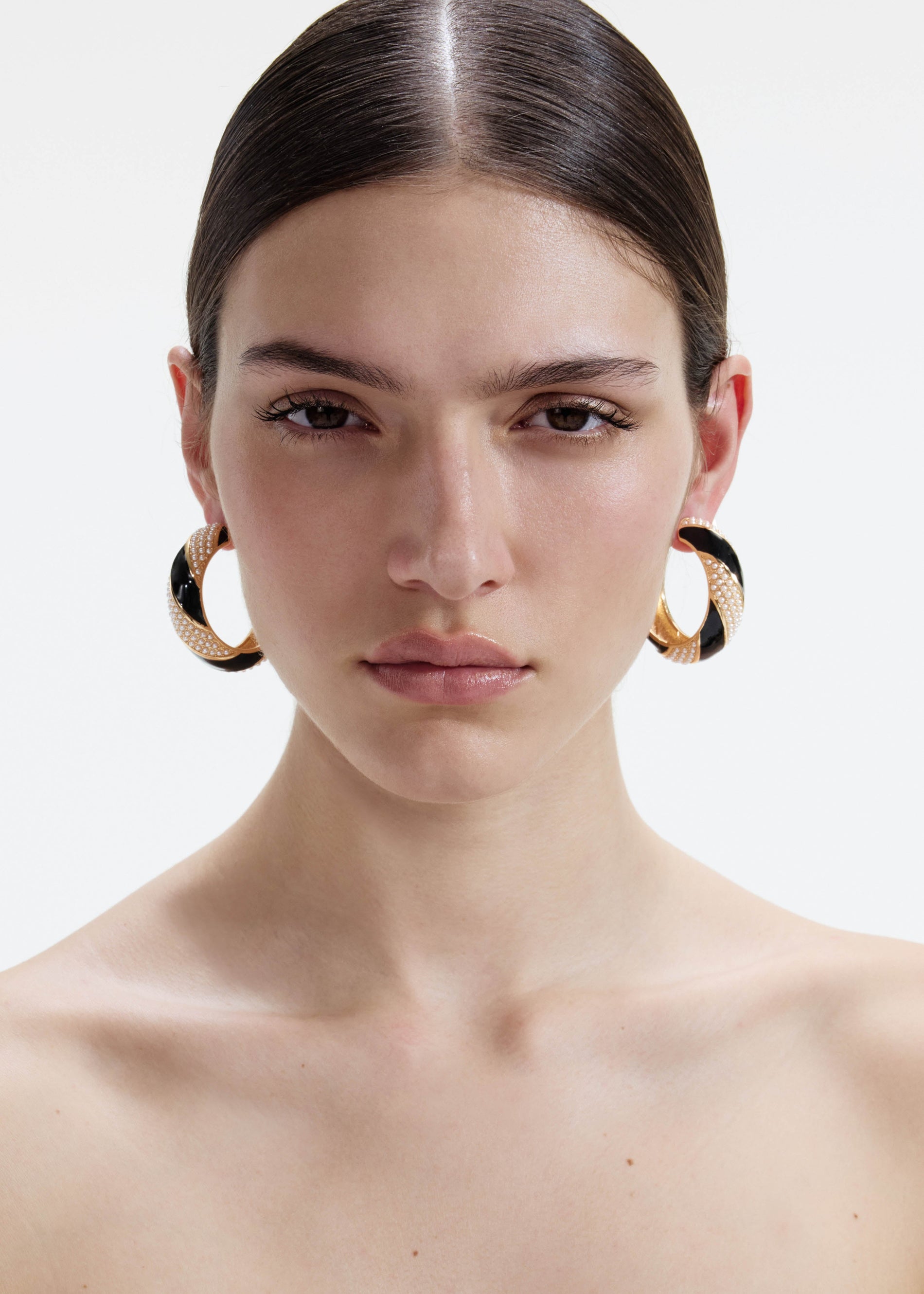 A photo of the Black And Gold Pearl Hoop Earrings