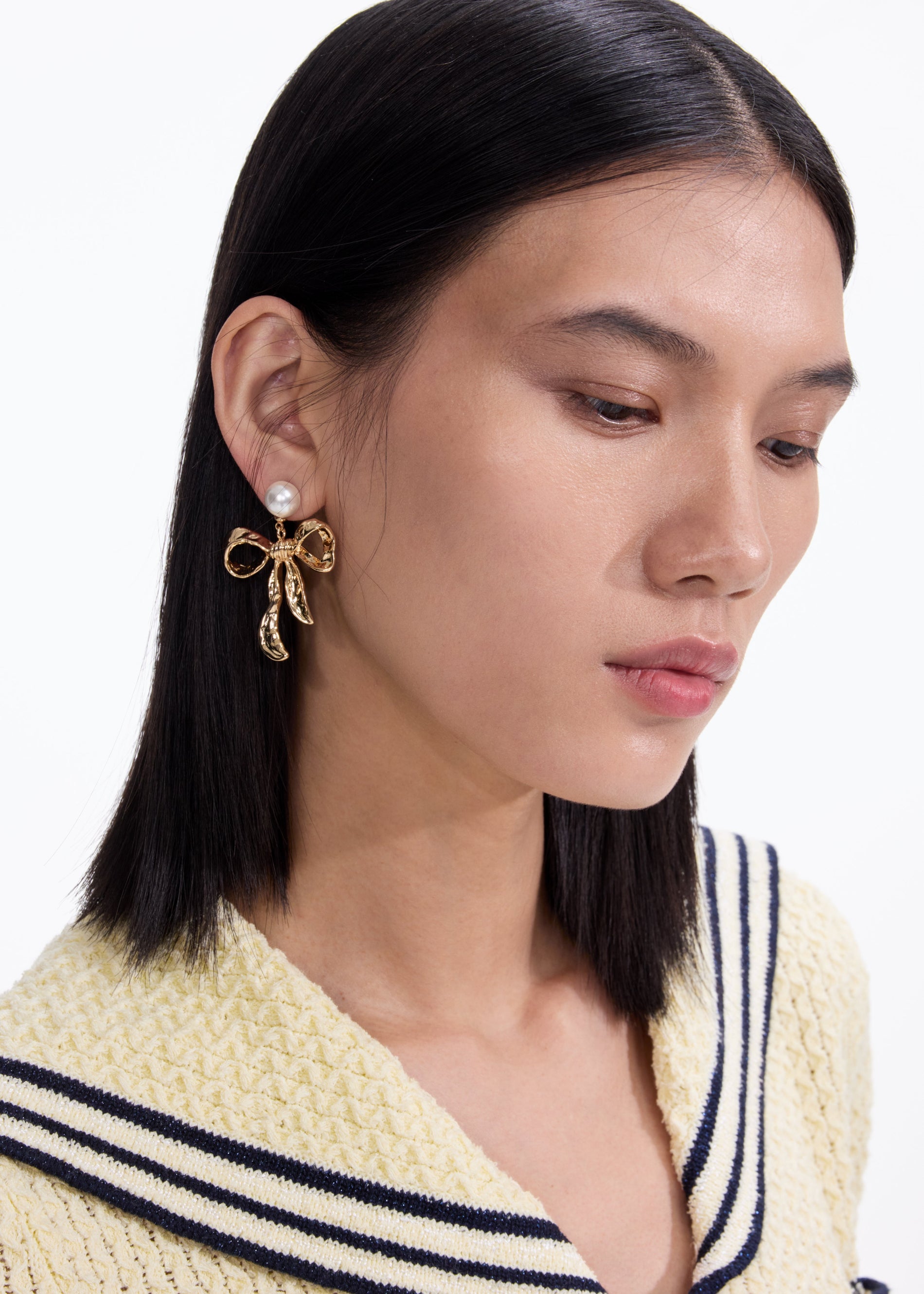 A photo of the Mottled Gold Bow Earrings