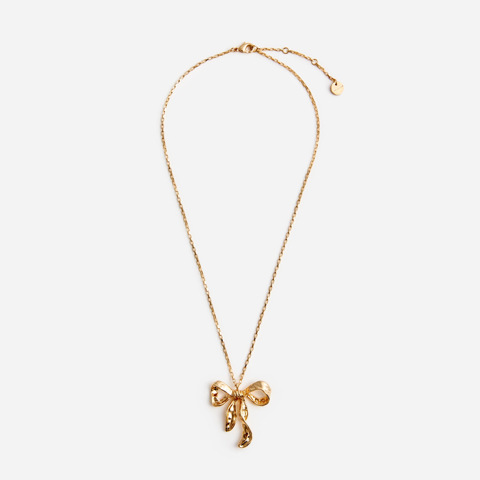 A photo of the Mottled Gold Bow Pendant Necklace