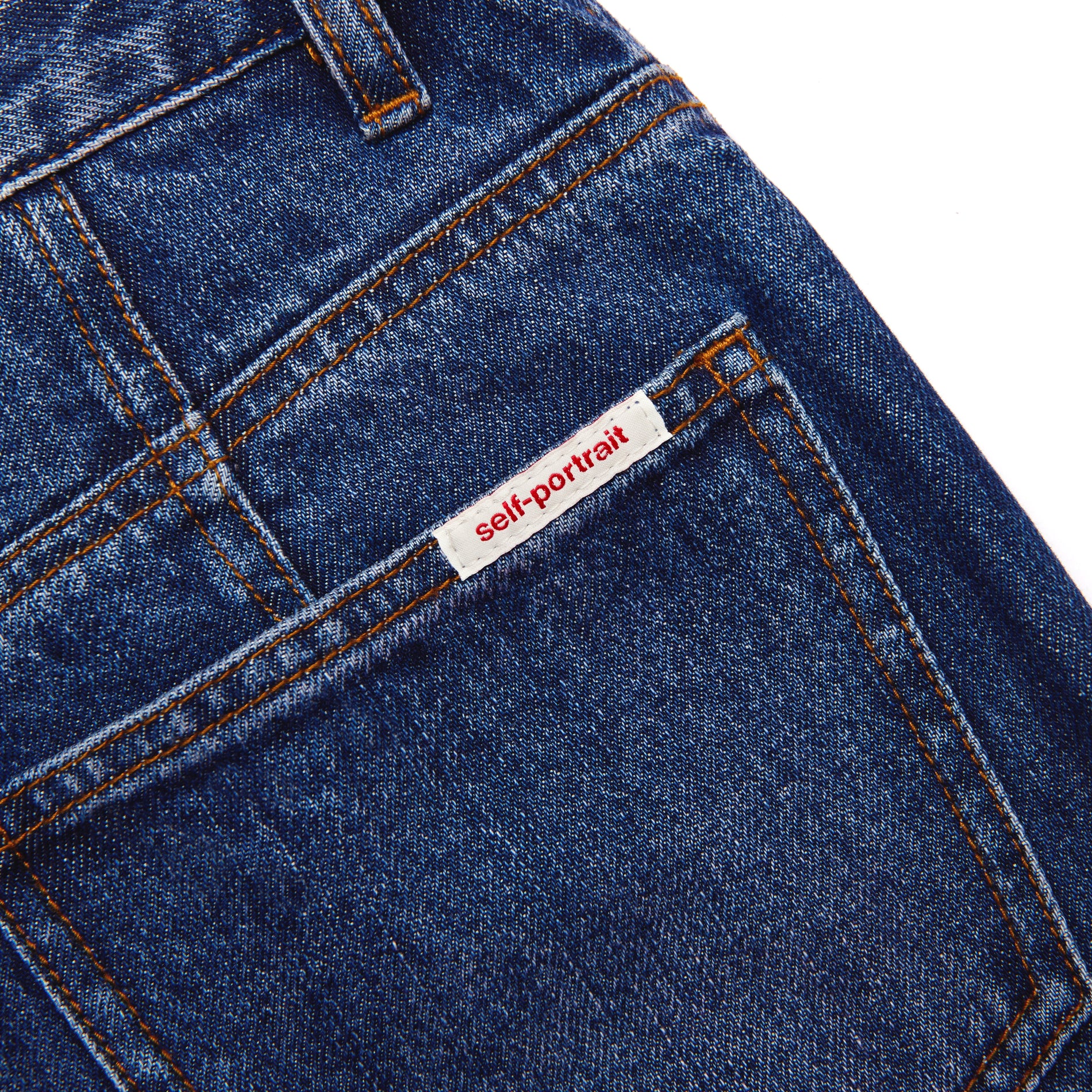 Side view of a woman wearing the Bleached Denim Jeans