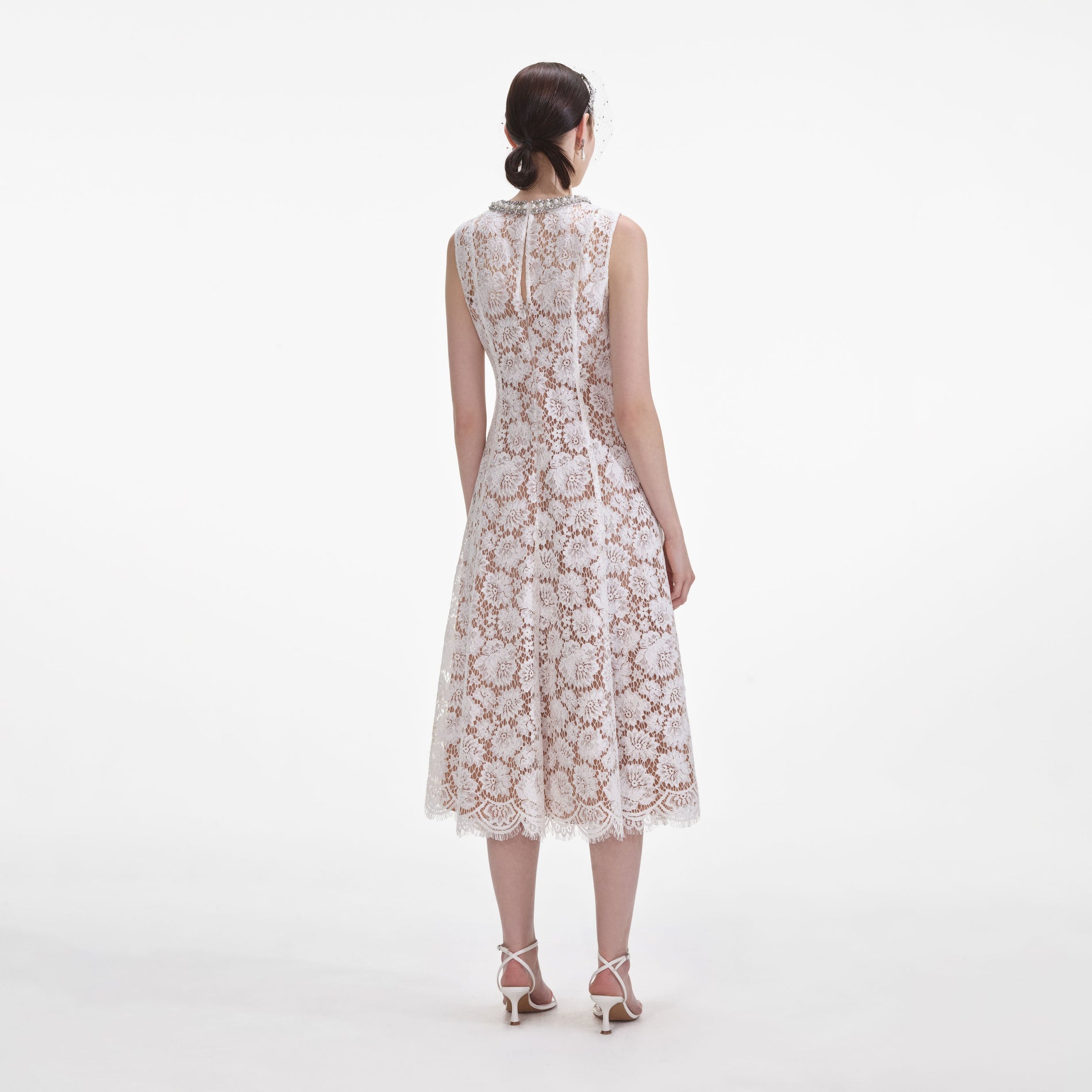 Back view of a woman wearing the White Fine Lace Pearl Midi Dress