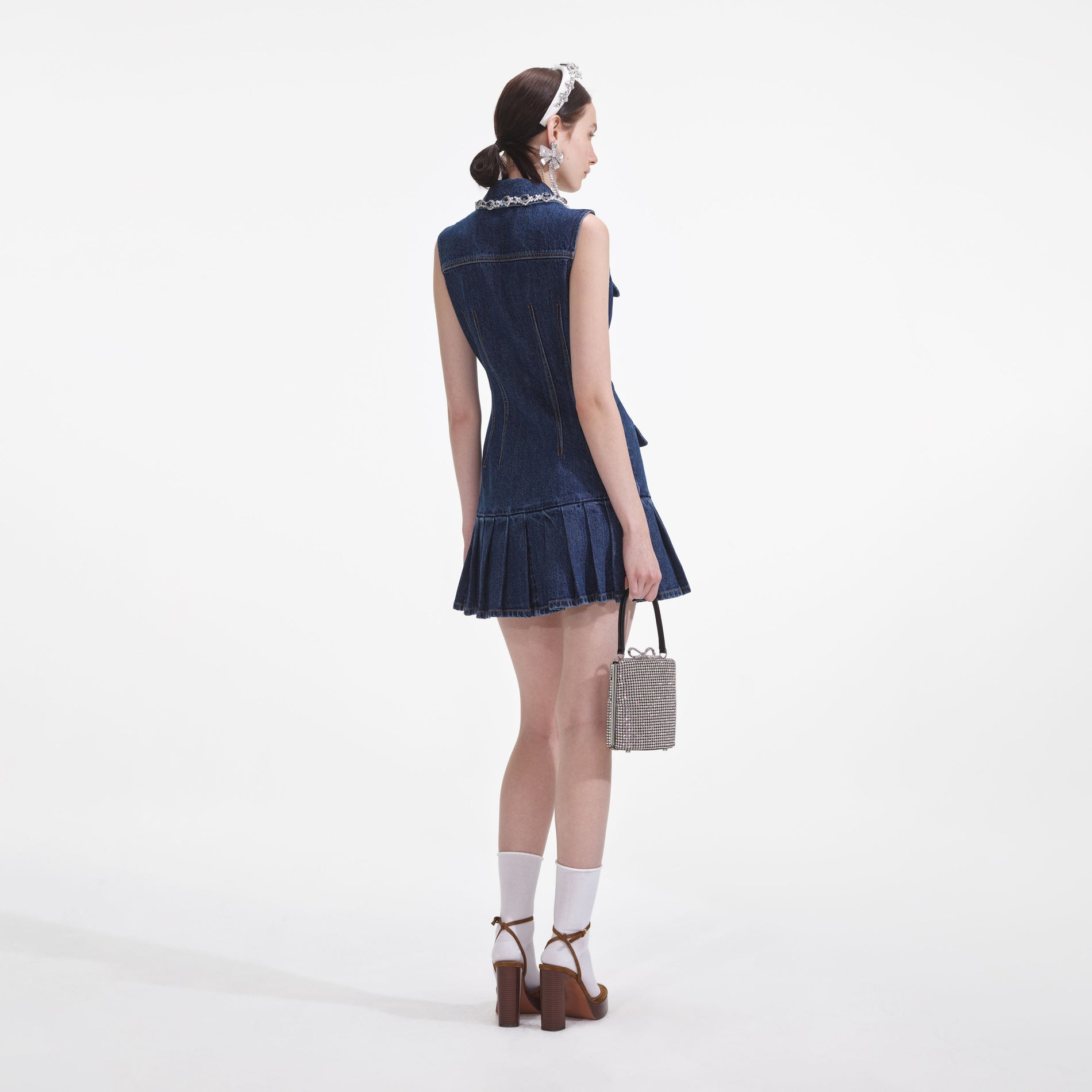 Back view of a woman wearing the Denim Sleeveless Mini Dress