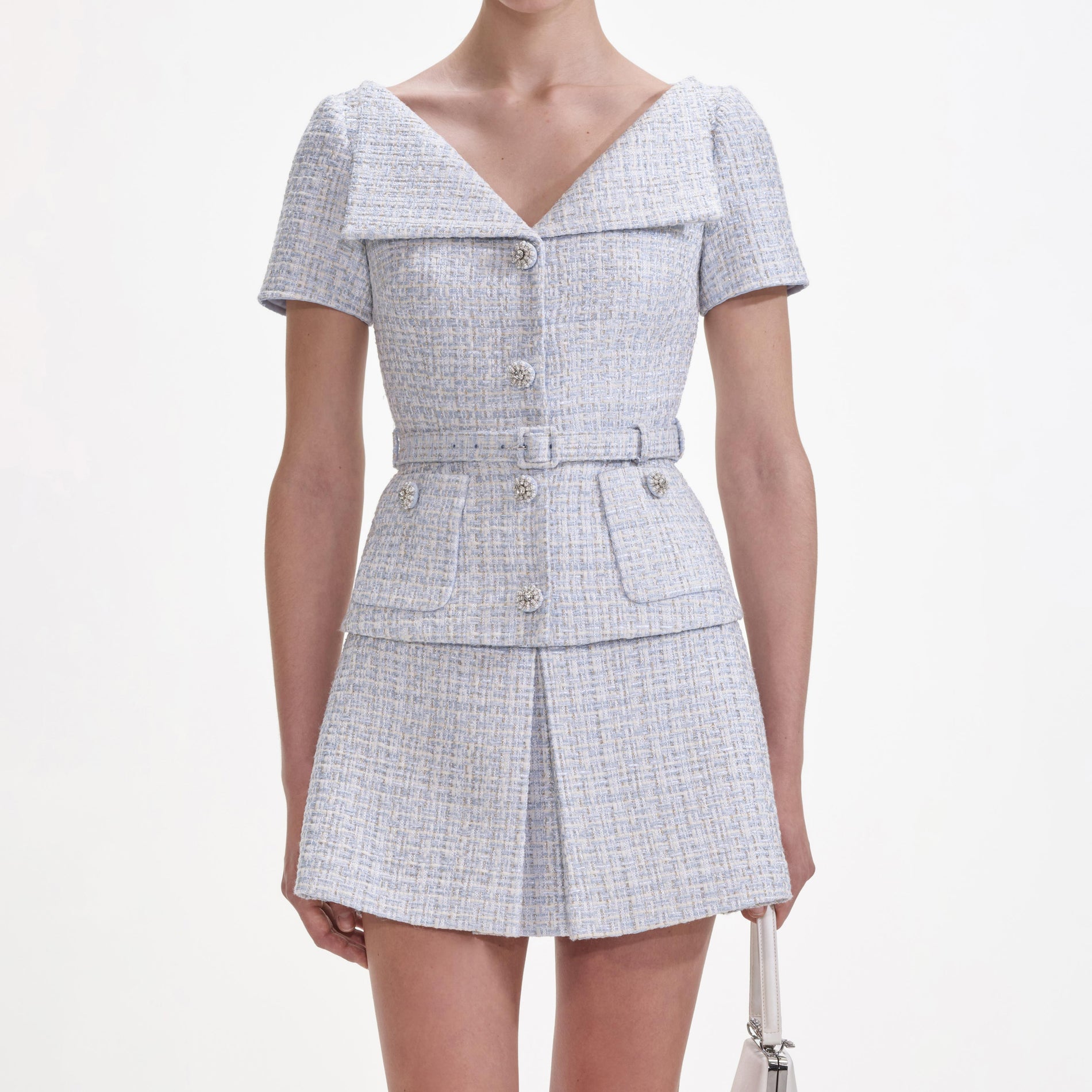 A close up of a woman wearing the Blue Boucle Top