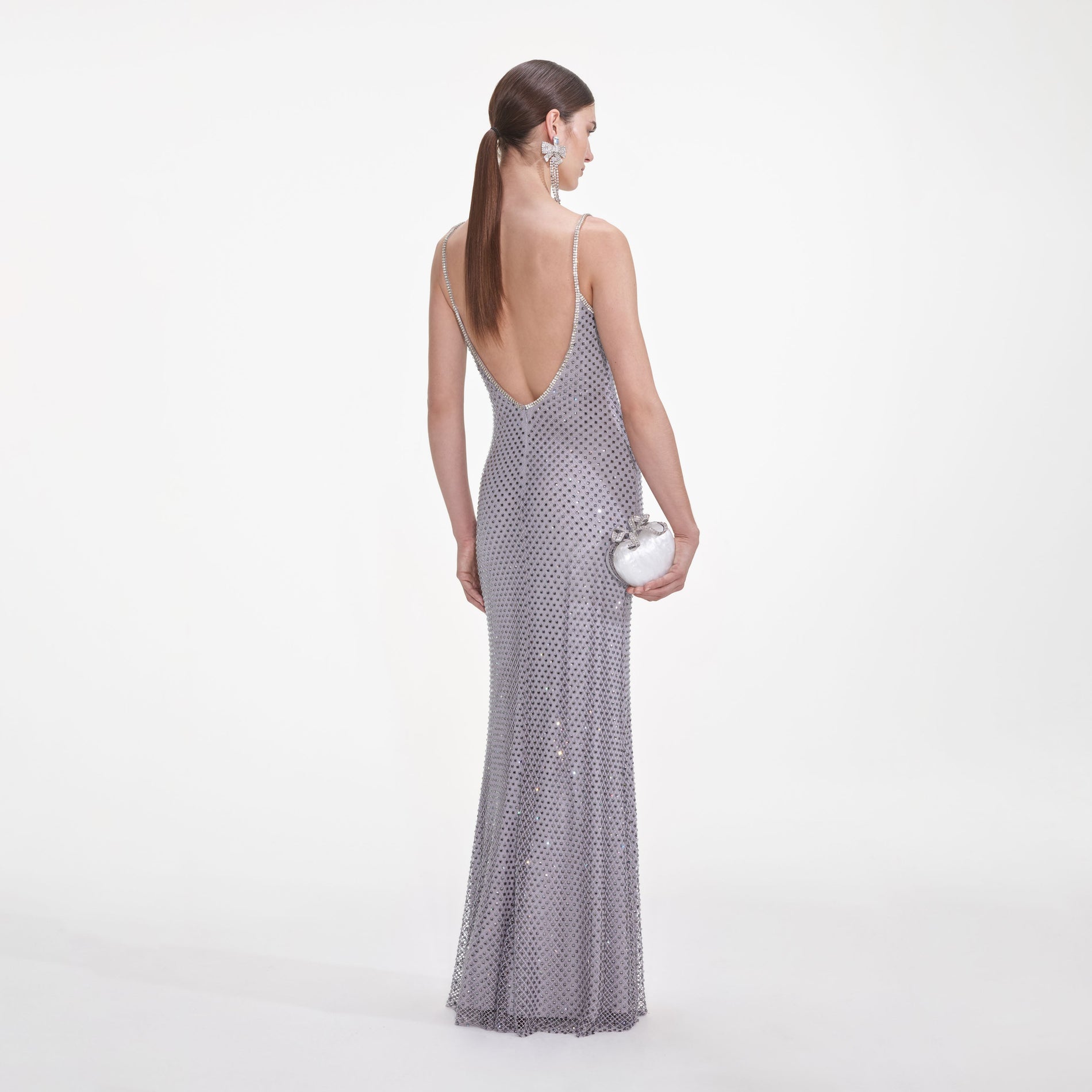 Back view of a woman wearing the Grey Square Rhinestone Fishnet Maxi Dress