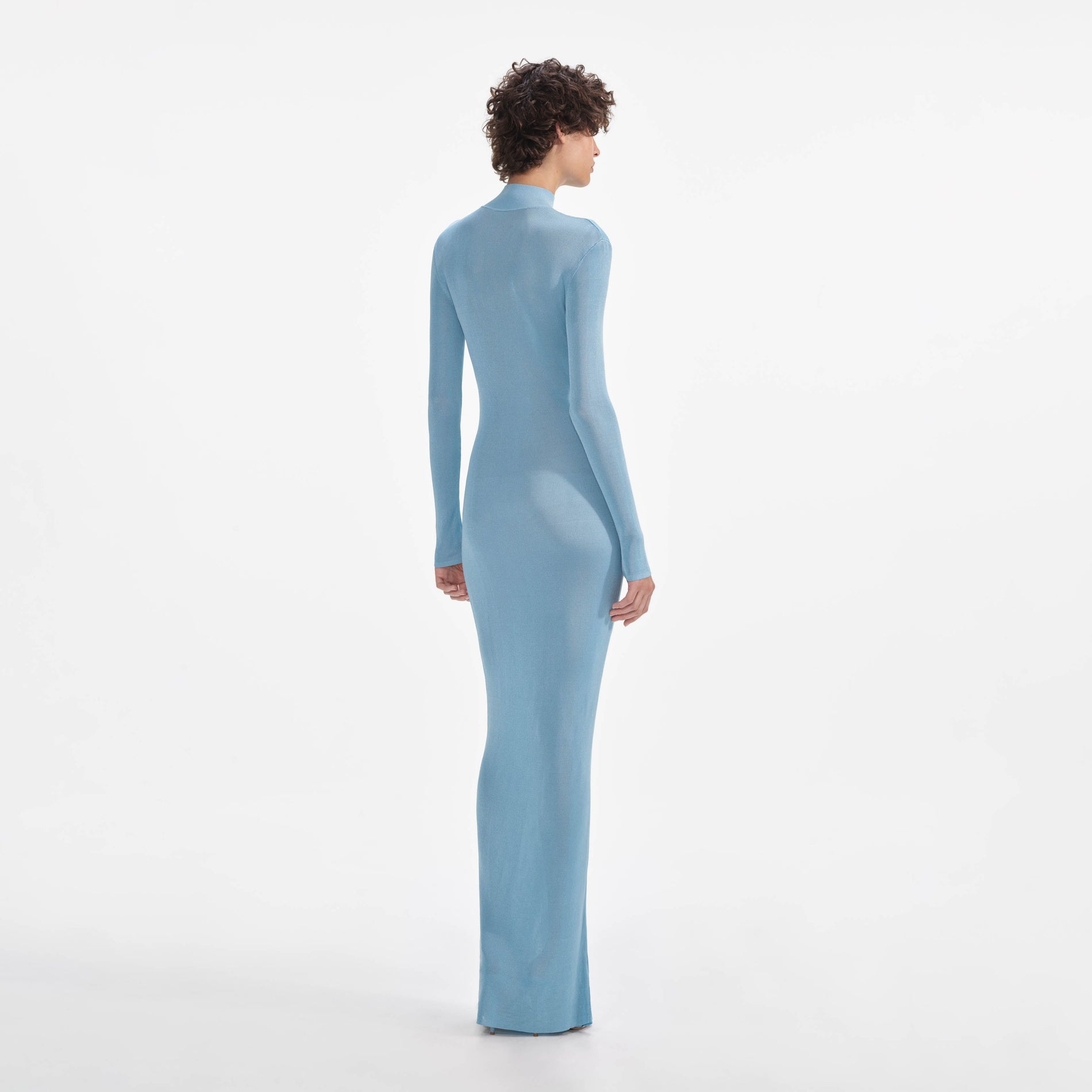 Back view of a woman wearing the Blue Knit Cut Out Maxi Dress