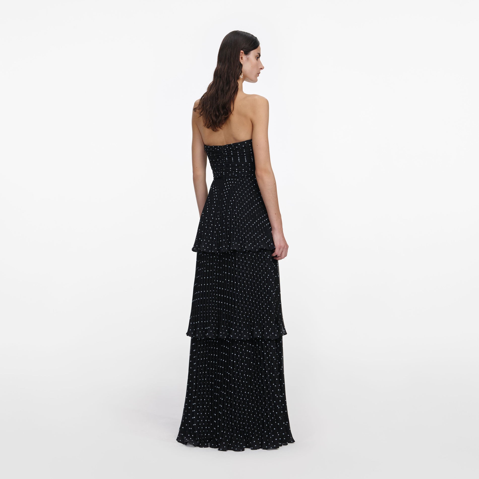 Back view of a woman wearing the Black Polka Dot Tiered Maxi Dress