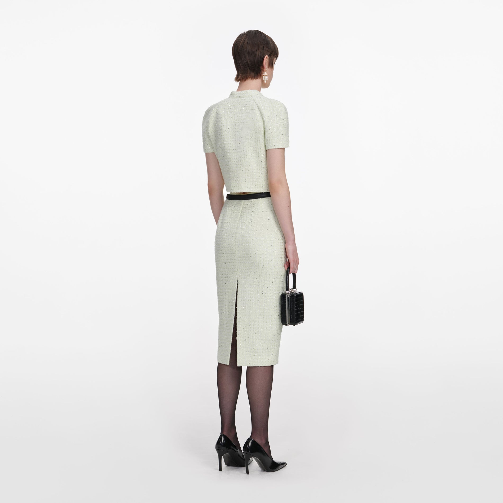 Back view of a woman wearing the Lime Boucle Top