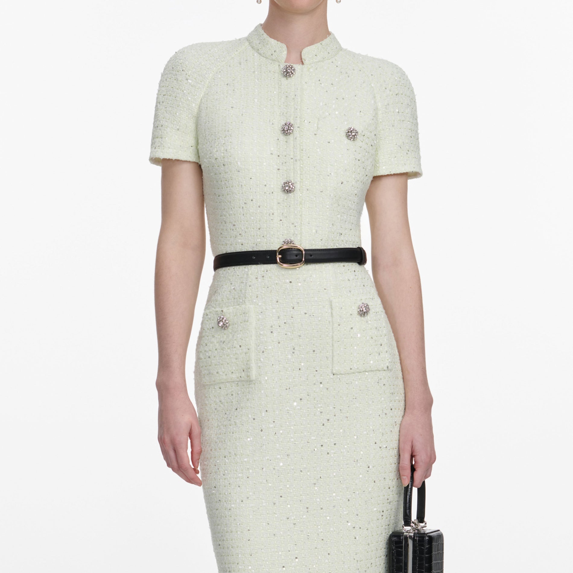 A close up of a woman wearing the Lime Boucle Top