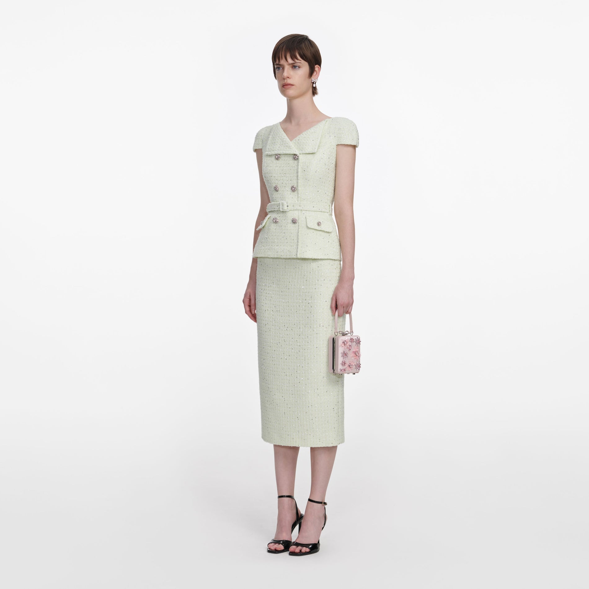 Side view of a woman wearing the Lime Boucle Midi Dress