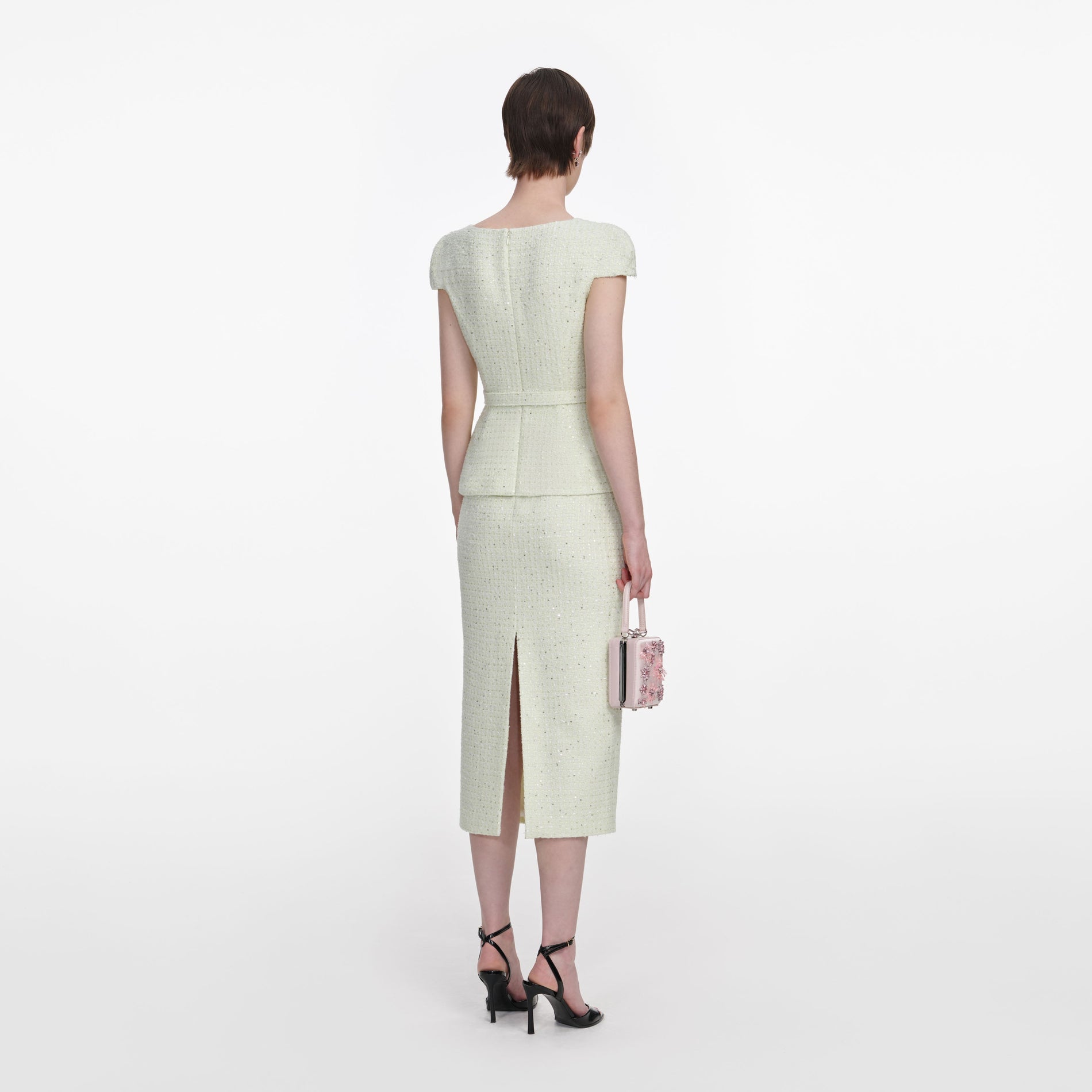 Back view of a woman wearing the Lime Boucle Midi Dress