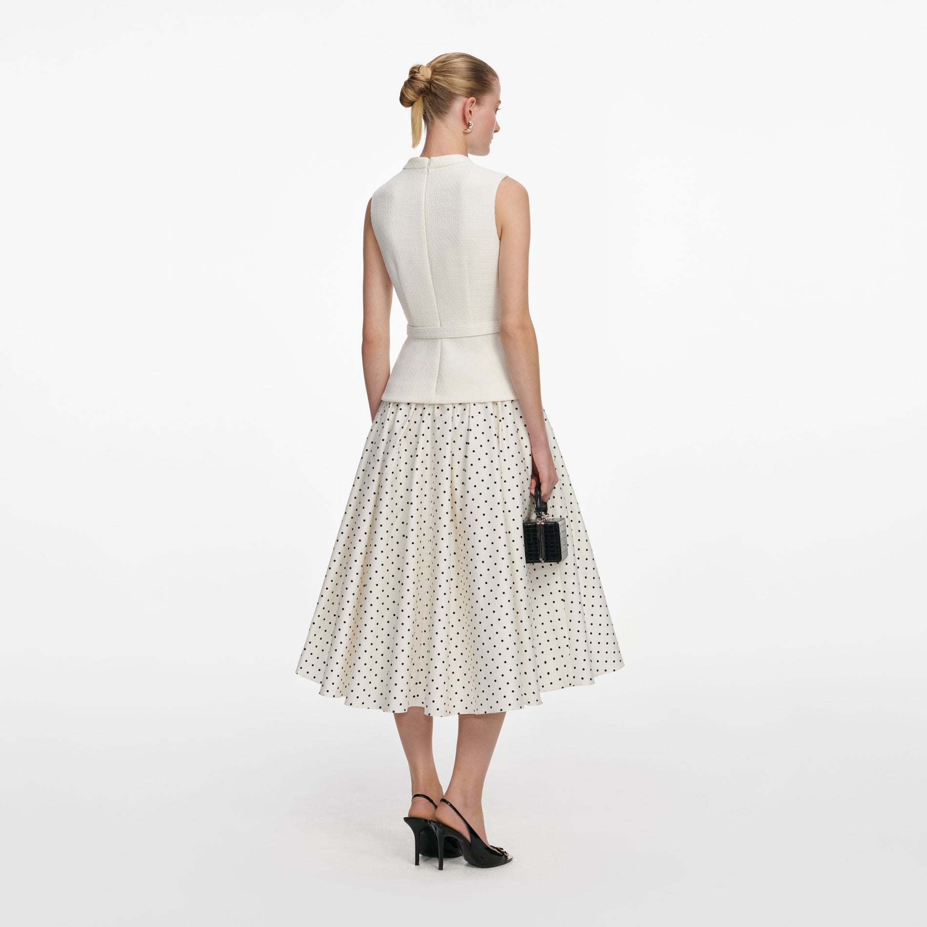 Back view of a woman wearing the Cream Boucle Polka Dot Midi Dress
