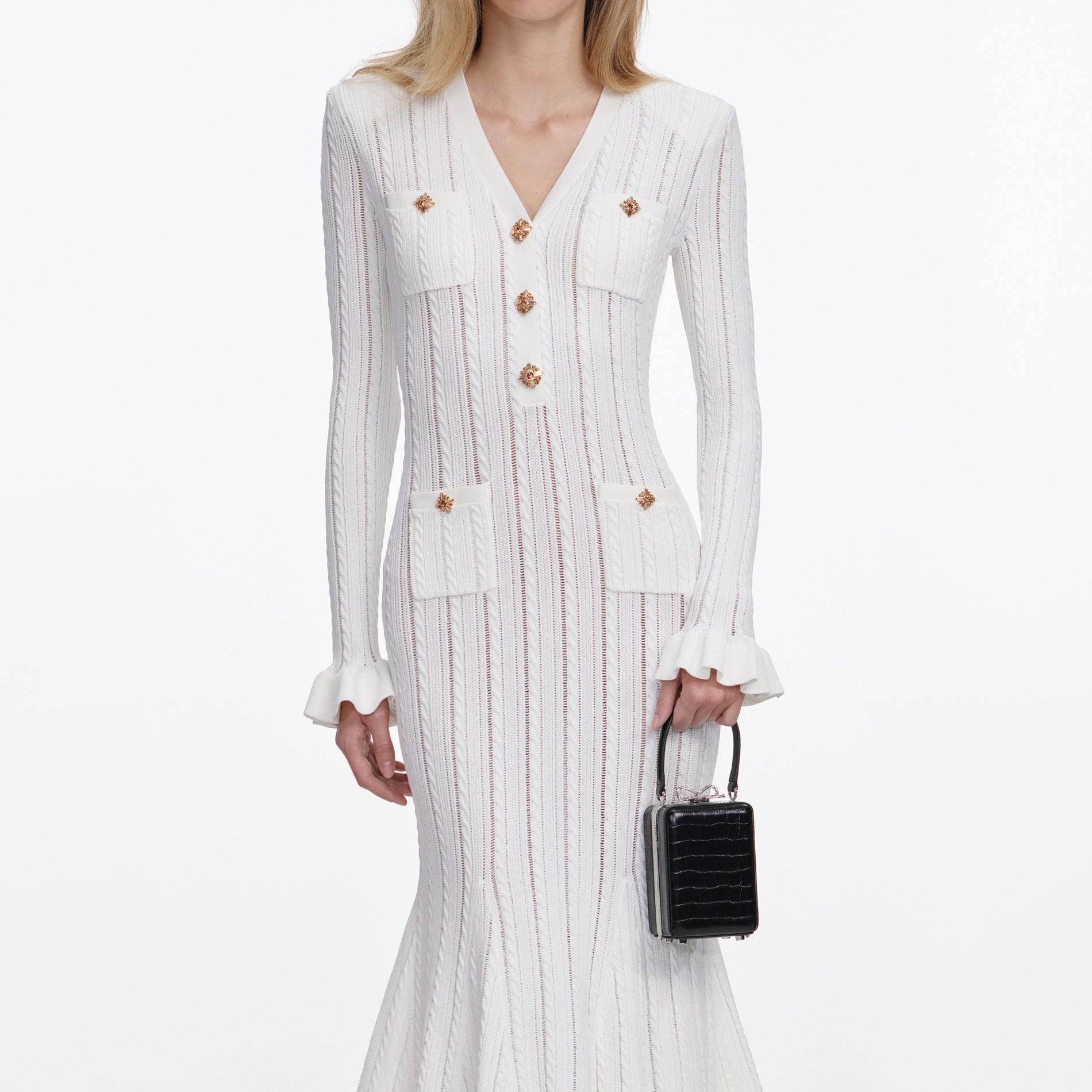 A close up of a woman wearing the White Pointelle Knit Midi Dress