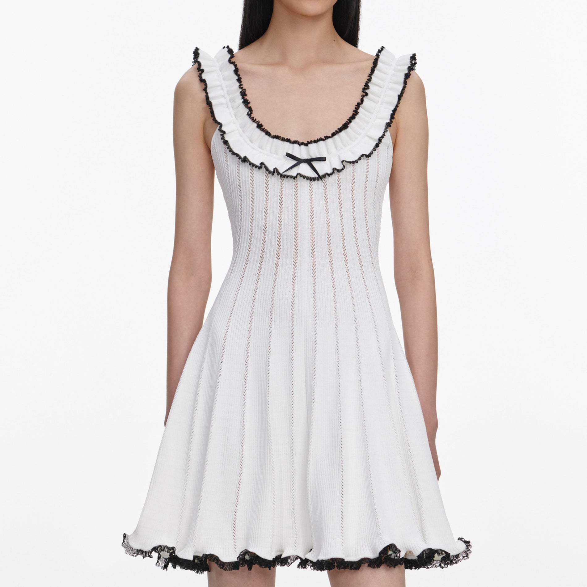 A close up of a woman wearing the White Contrast Trim Knit Mini Dress