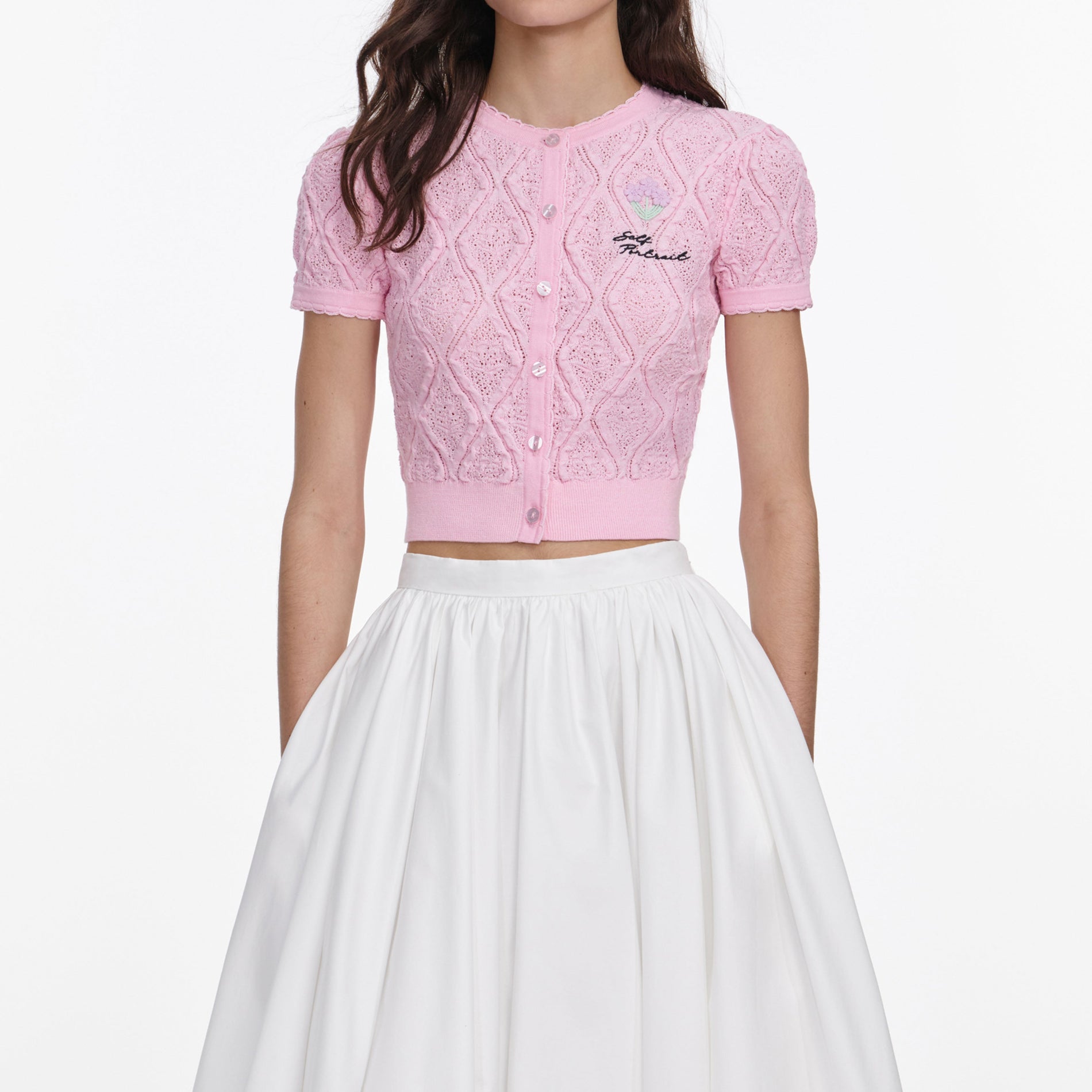 A close up of a woman wearing the Pink Pointelle Knit Top