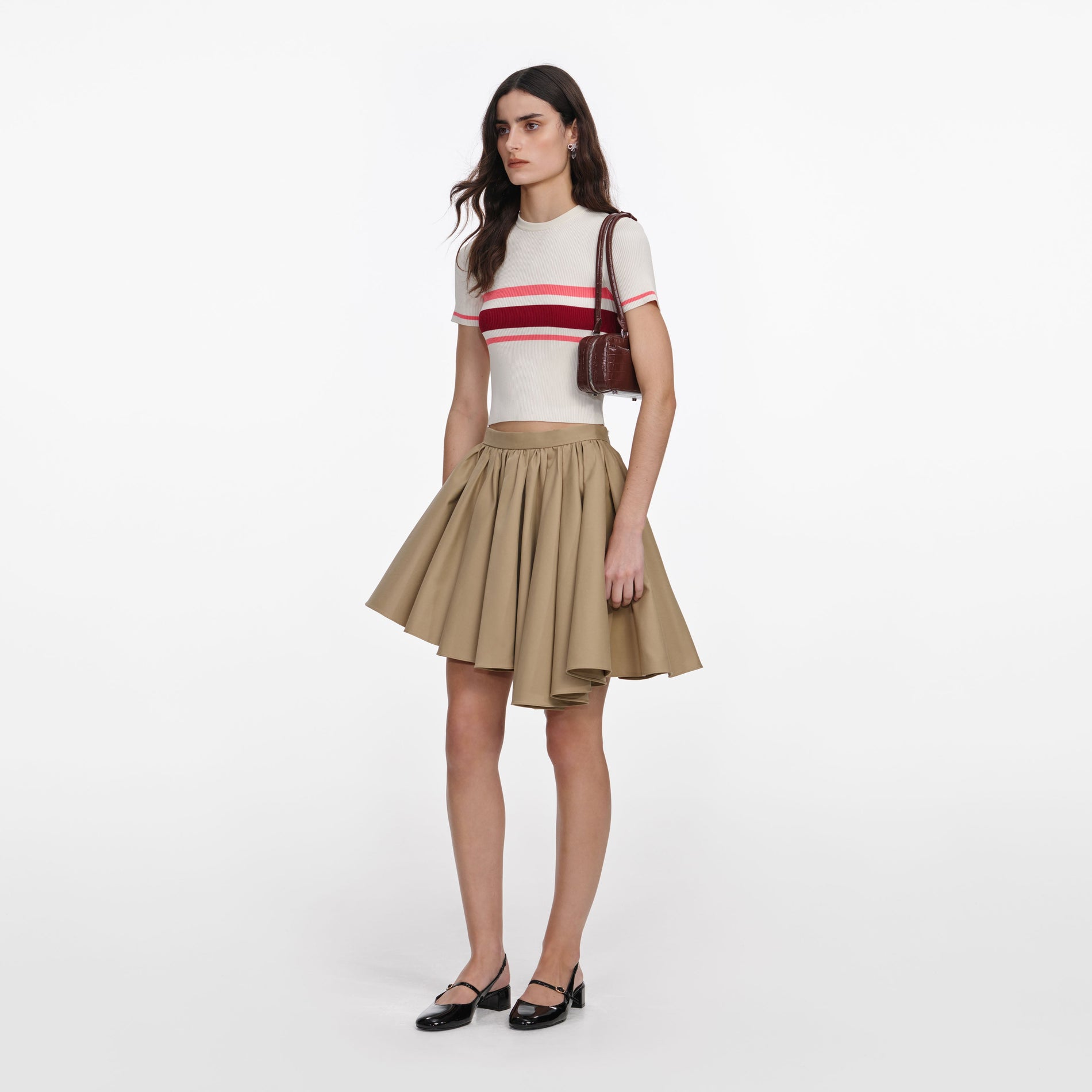 Side view of a woman wearing the Cream Stripe Viscose Knit Top