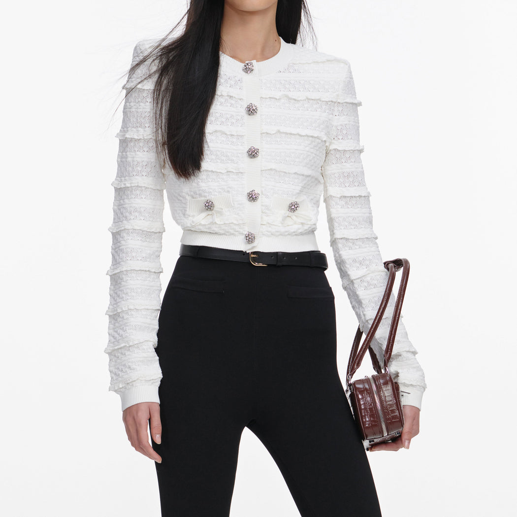 A close up of a woman wearing the White Pointelle Diamante Cardigan