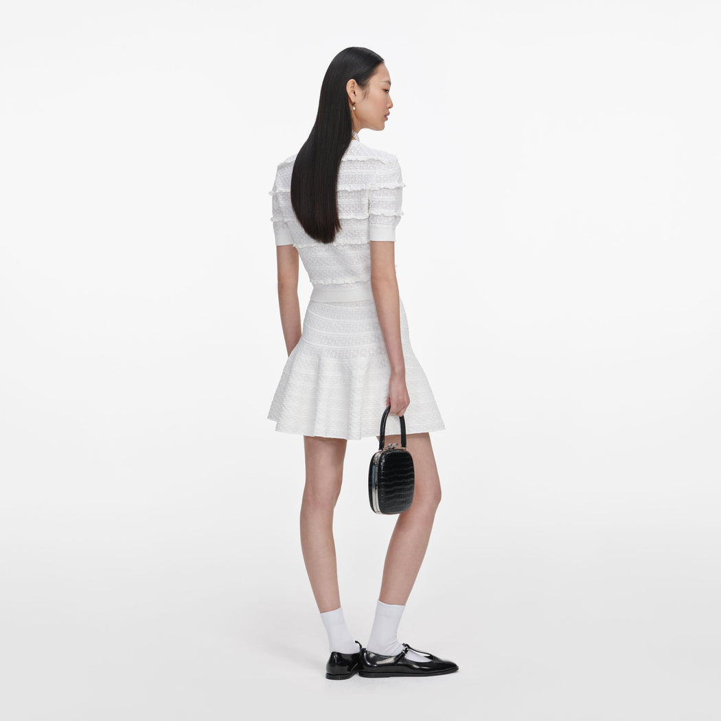 Back view of a woman wearing the White Pointelle Knit Top