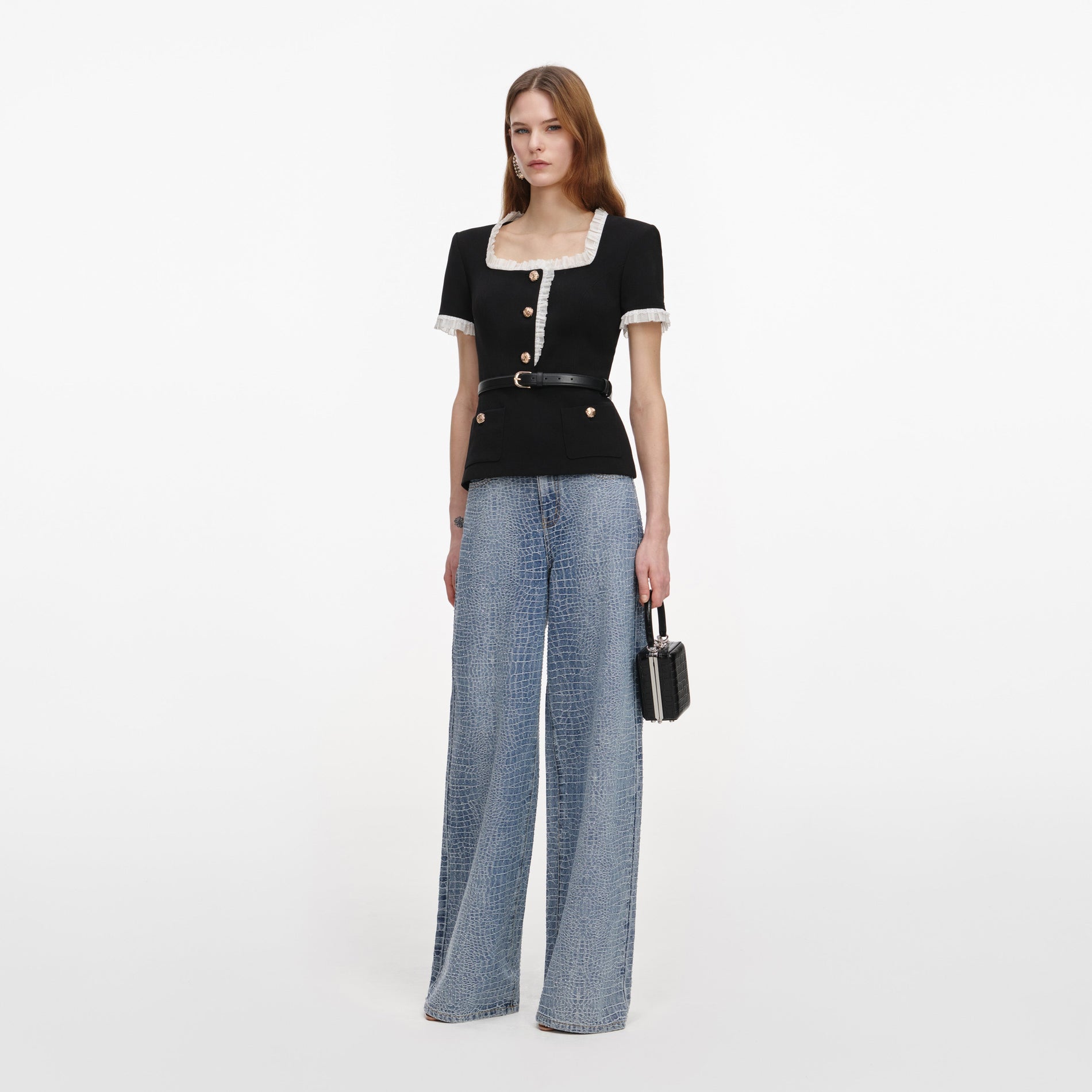 Side view of a woman wearing the Black Crepe Contrast Frill Top