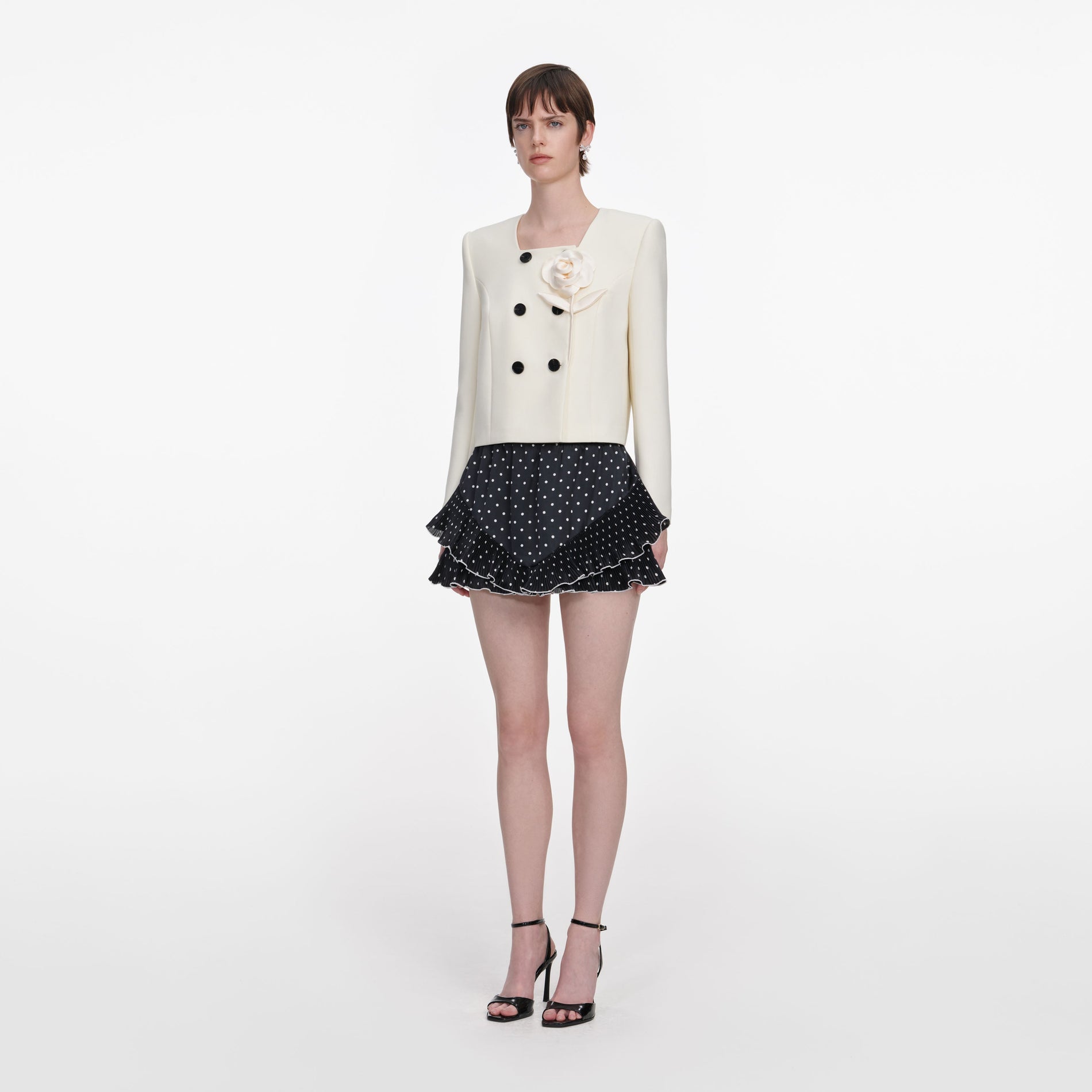 Side view of a woman wearing the Cream 3D Flower Jacket