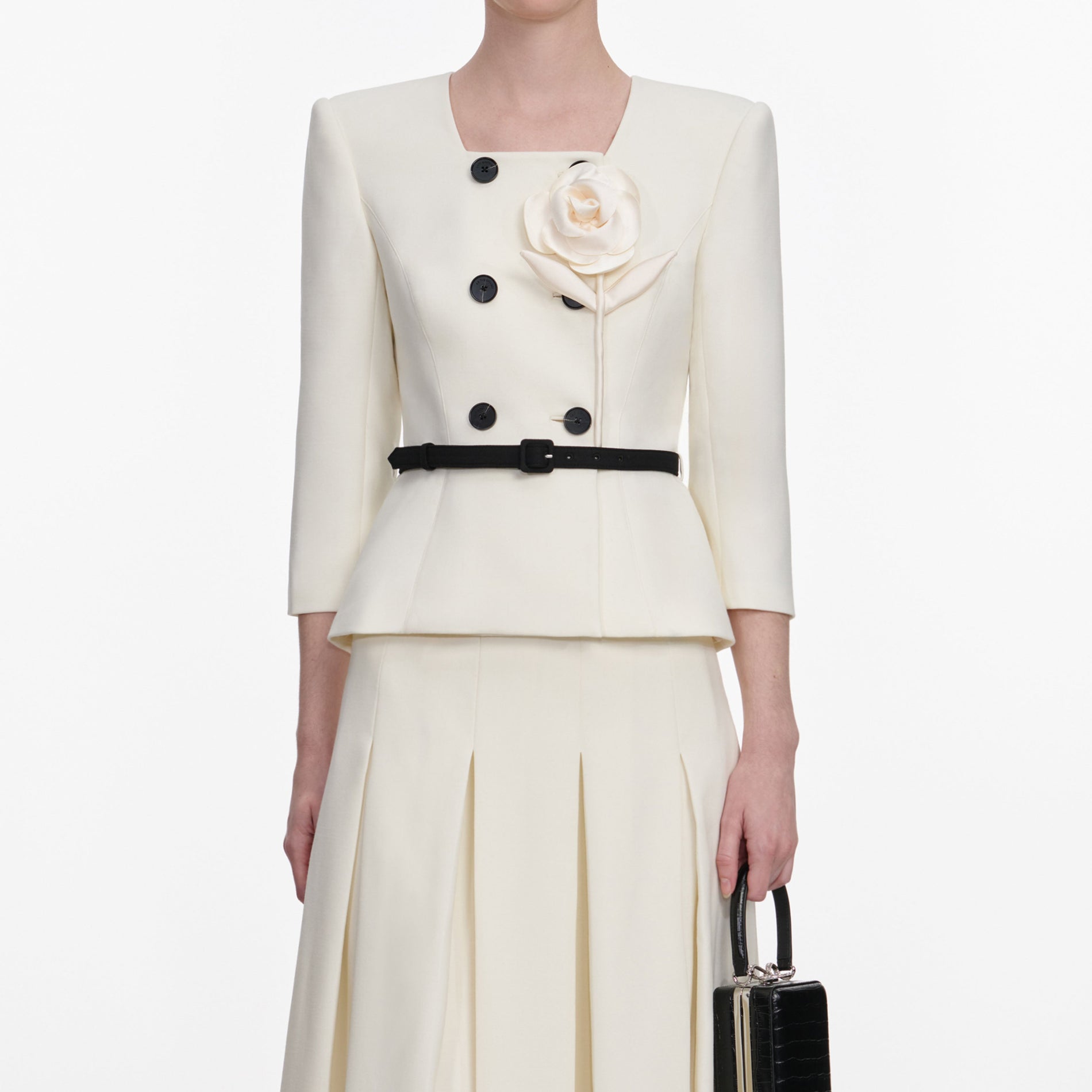 A close up of a woman wearing the Cream 3D Flower Tailored Midi Dress