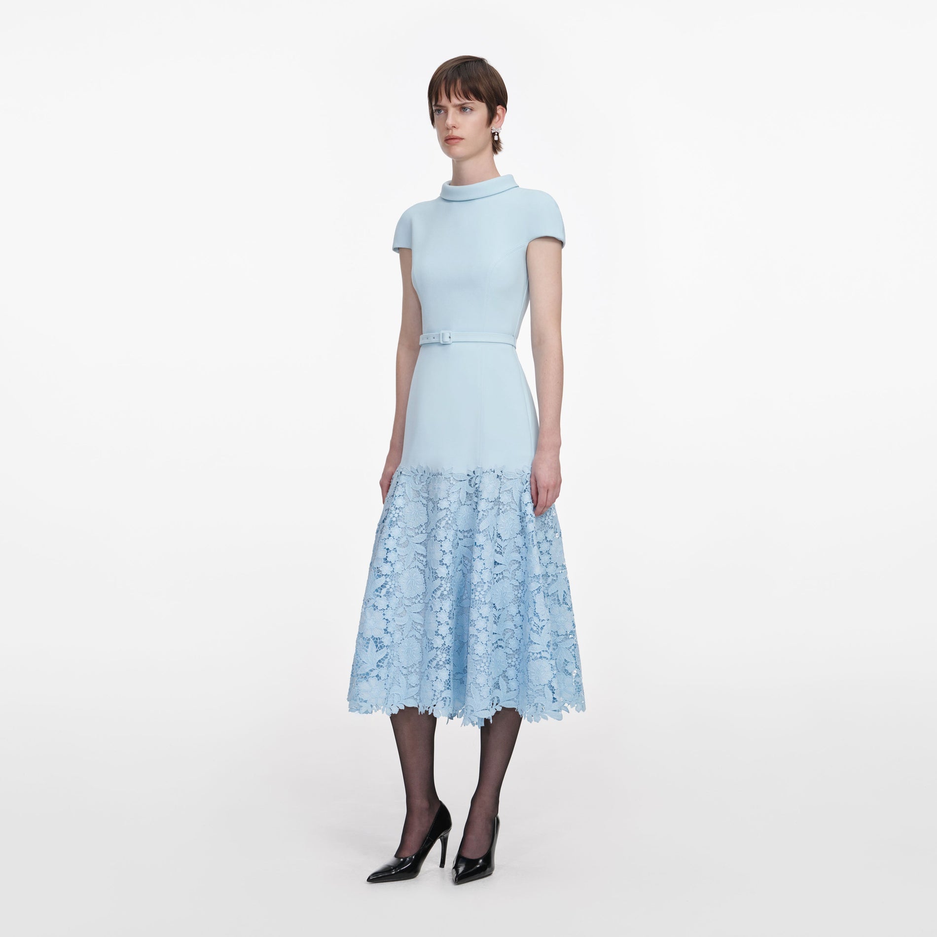 Side view of a woman wearing the Blue Crepe Lace Midi Dress