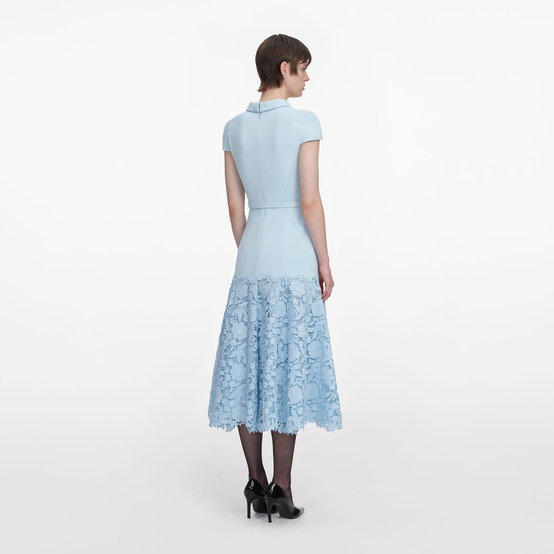 Back view of a woman wearing the Blue Crepe Lace Midi Dress