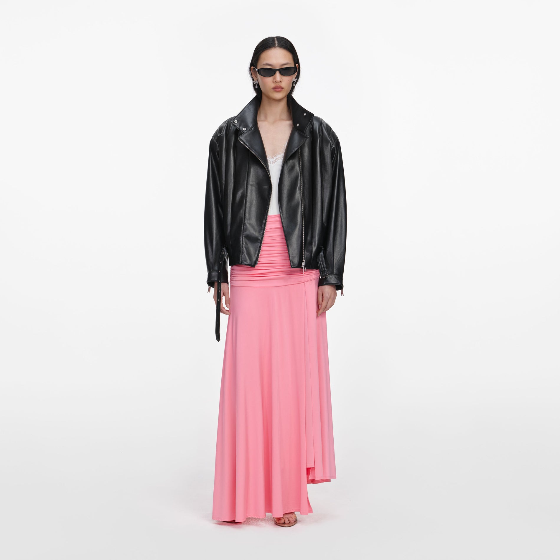 A close up of a woman wearing the Black Faux Leather Biker Jacket