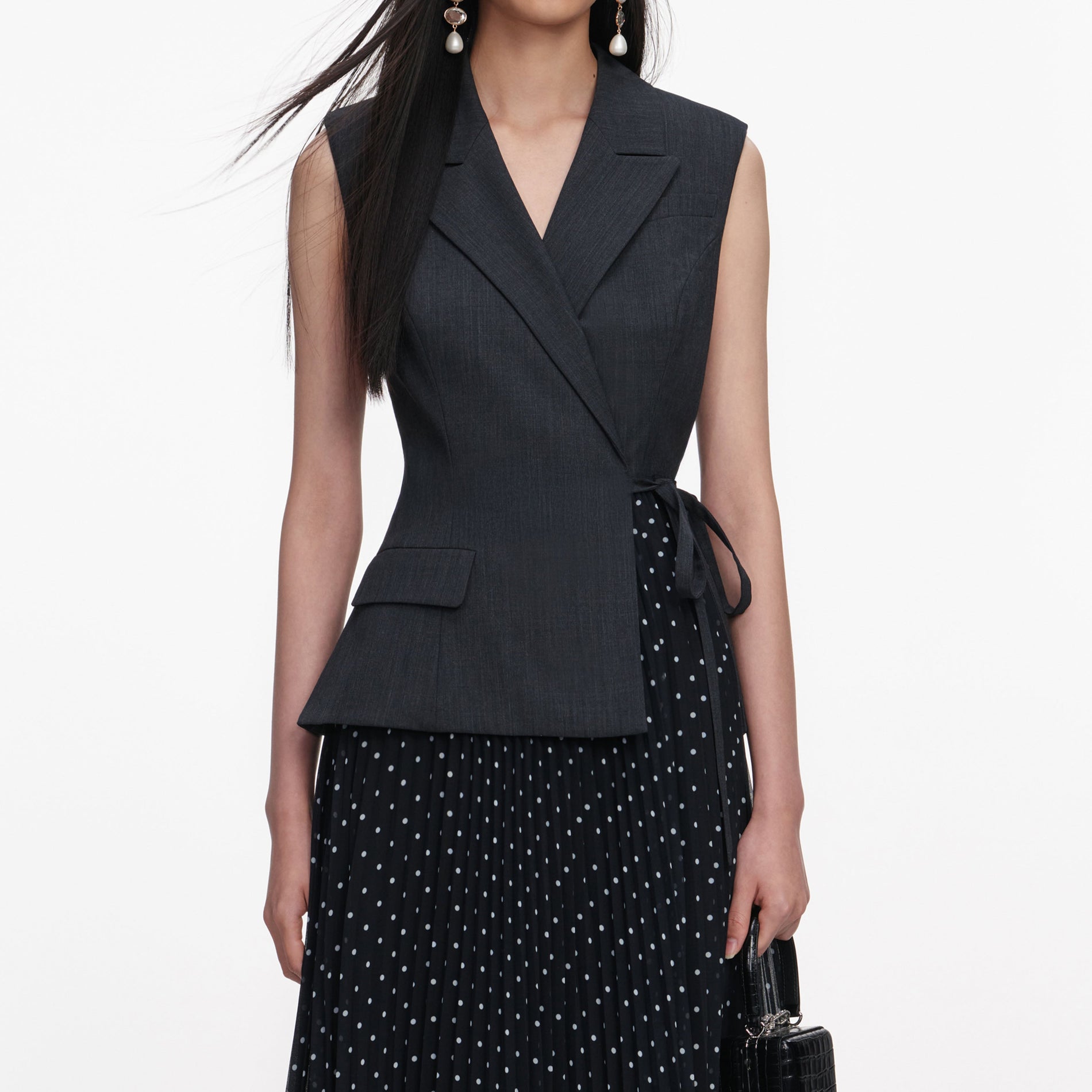 A close up of a woman wearing the Grey Tailored Polka Dot Midi Dress