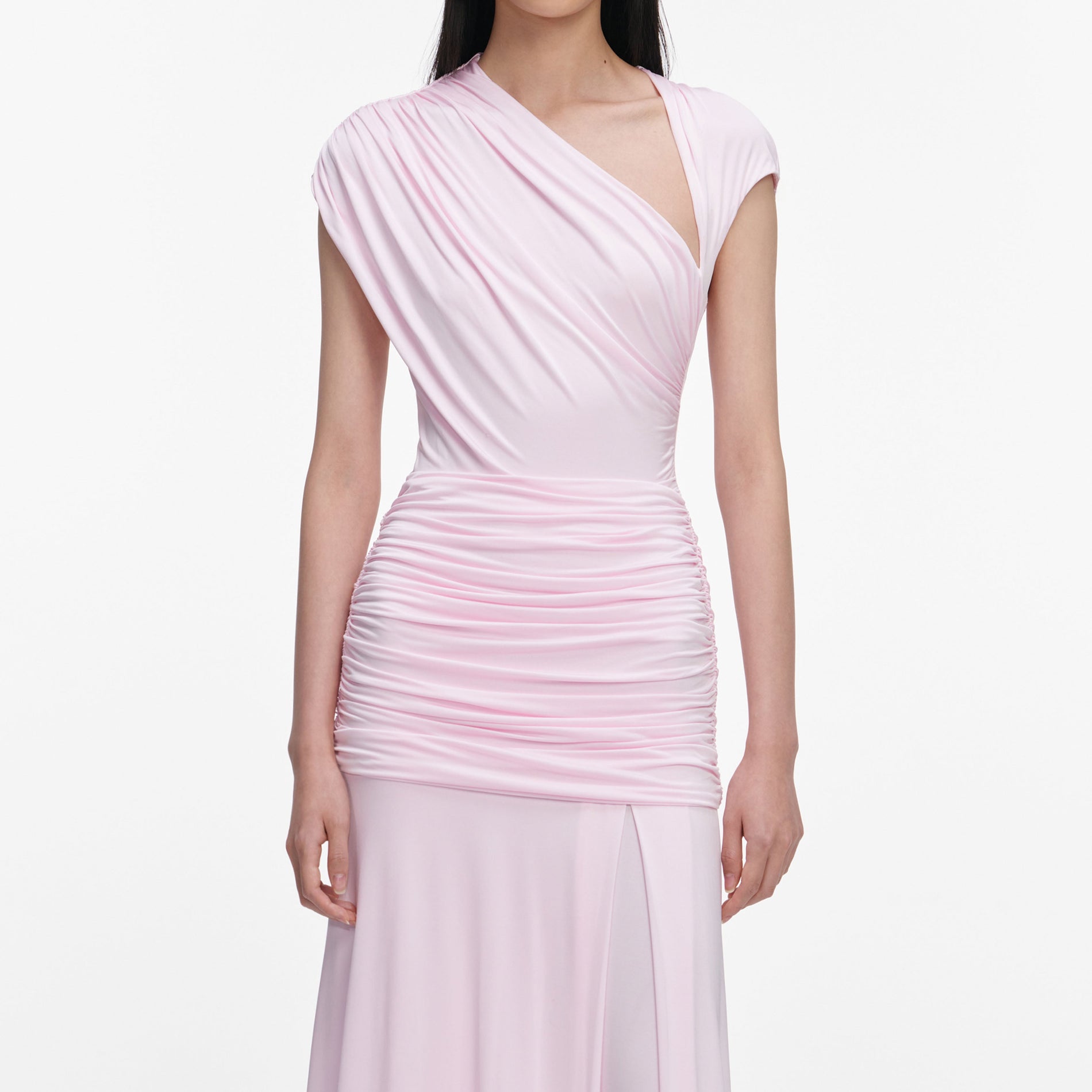 A close up of a woman wearing the Pink Jersey Draped Maxi Dress