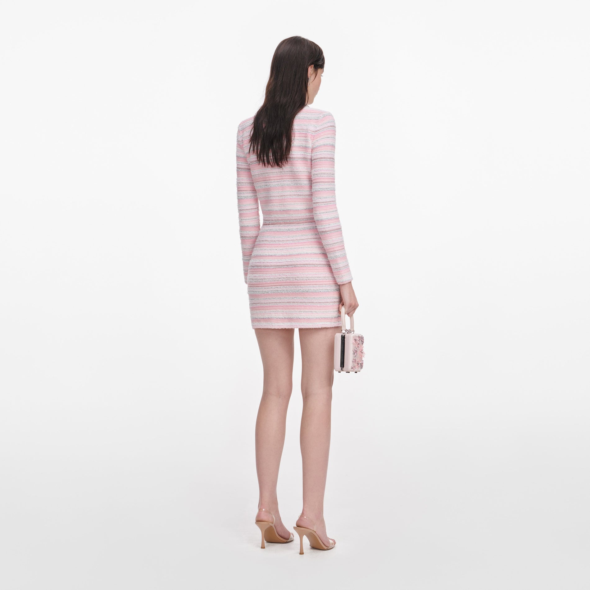 Back view of a woman wearing the Pink Textured Knit Mini Skirt
