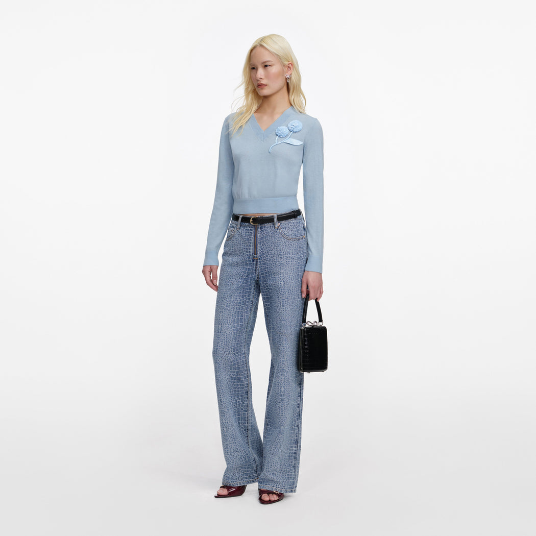 Side view of a woman wearing the Blue Rose Wool Jumper