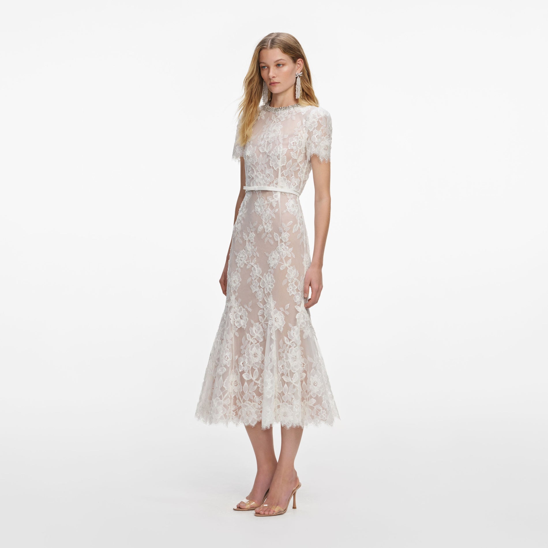 Side view of a woman wearing the White Sequin Lace Midi Dress