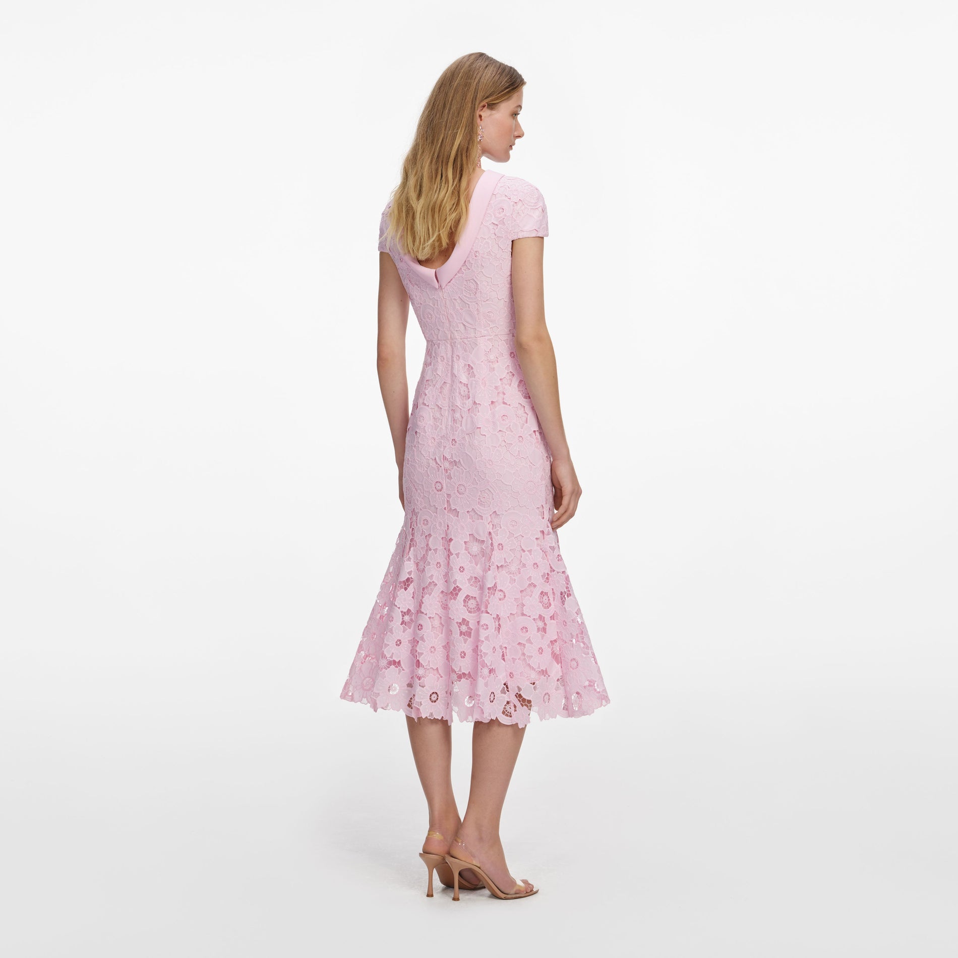 Back view of a woman wearing the Pink Lace Scoop Back Midi Dress