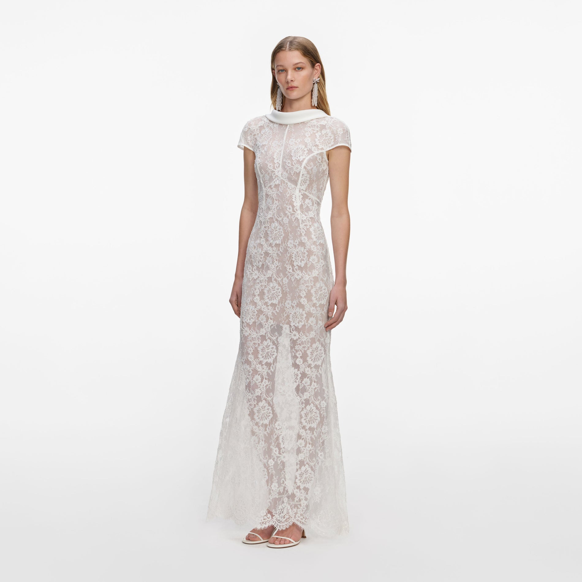 Side view of a woman wearing the White Lace Scoop Back Maxi Dress