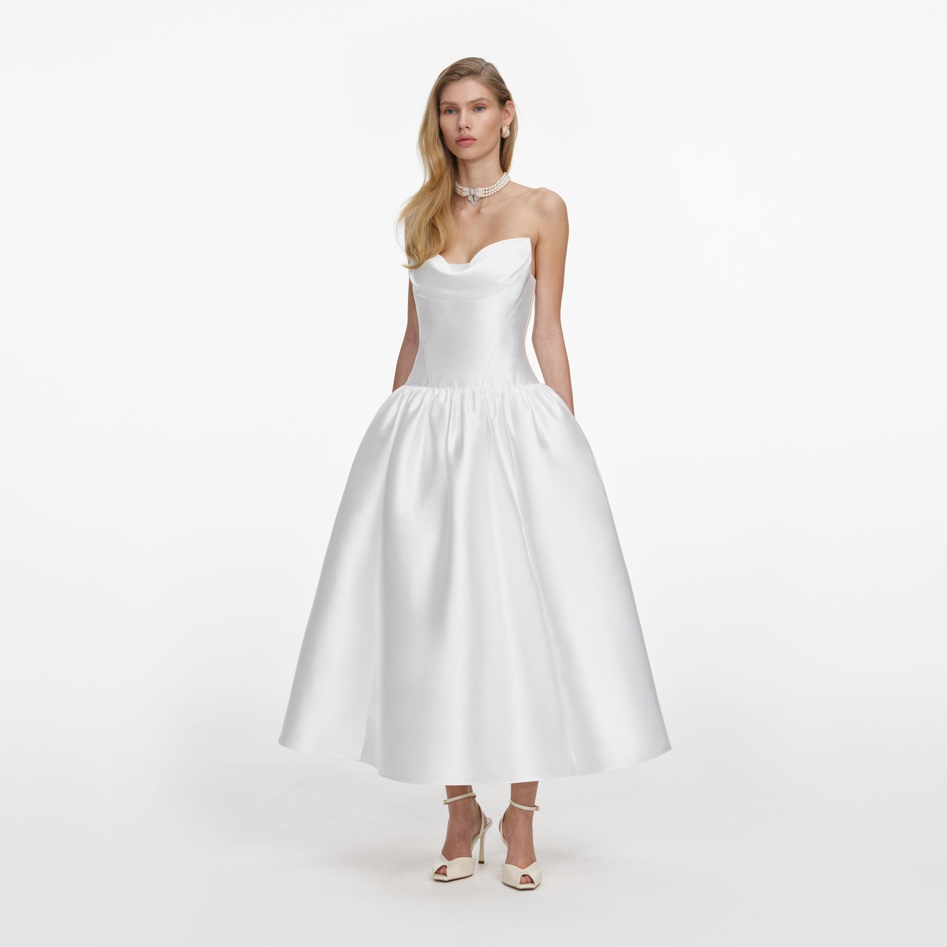 Side view of a woman wearing the White Taffeta Strapless Midi Dress